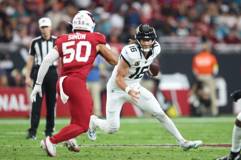 Jacksonville Jaguars quarterback Trevor Lawrence (16) rushes as Arizona Cardinals linebacker Cody Simon (50) defends during the first quarter at State Farm Stadium.