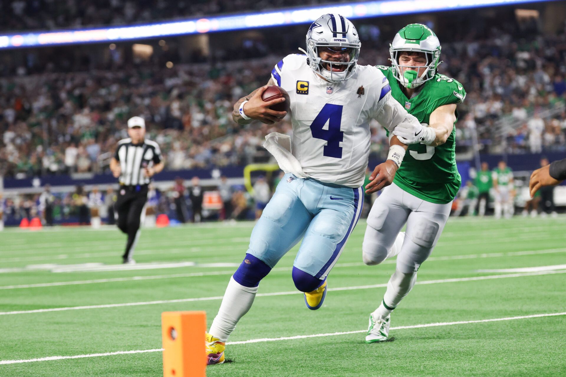 Dallas Cowboys quarterback Dak Prescott (4) runs with the ball in attempt to score a touchdown in the fourth quarter against the Philadelphia Eagles at AT&T Stadium.