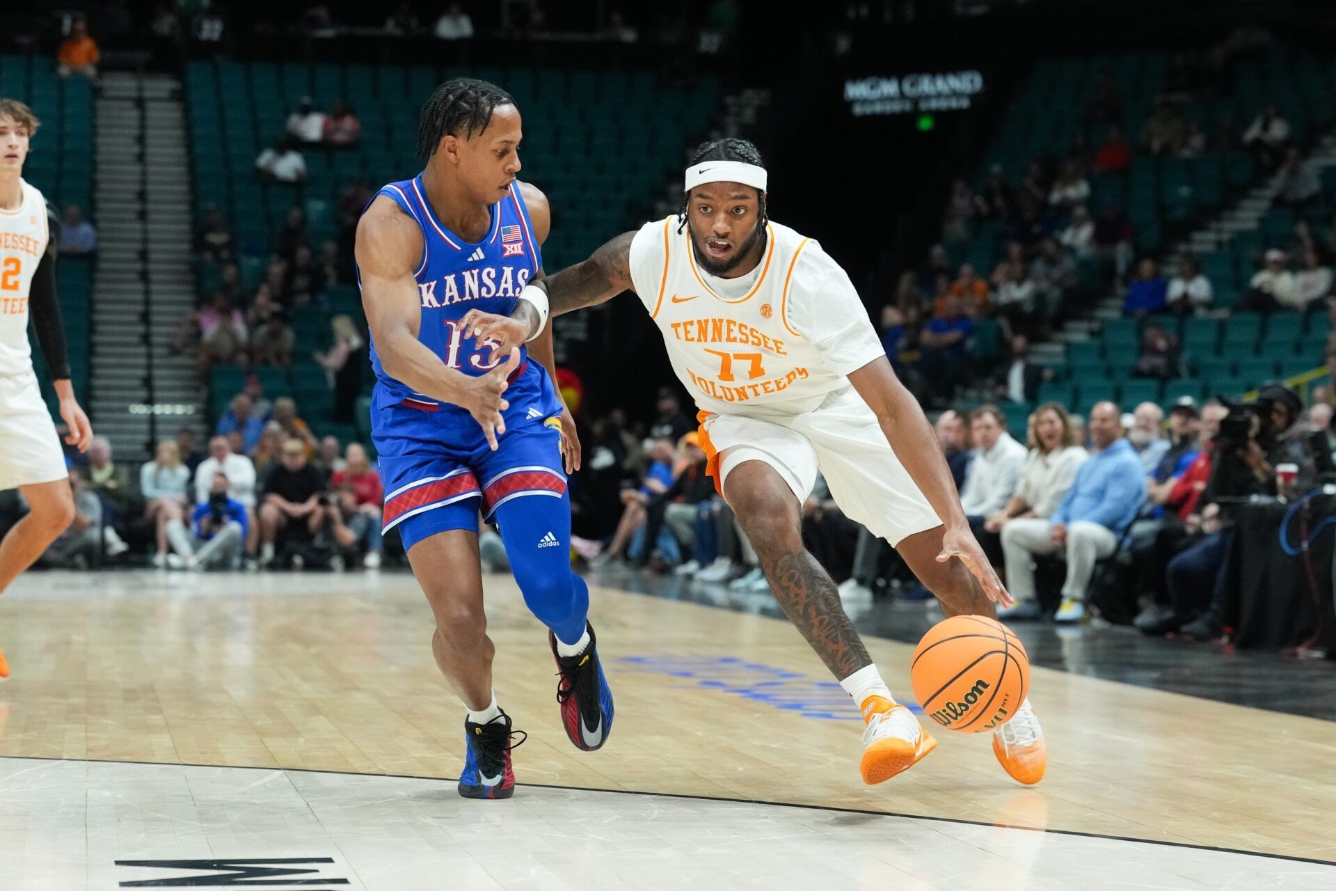Tennessee Volunteers guard Amaree Abram (77) drives the ball past Kansas Jayhawks guard Elmarko Jackson (13) in the 2025 Players Era Festival third place game at MGM Grand Garden Arena.