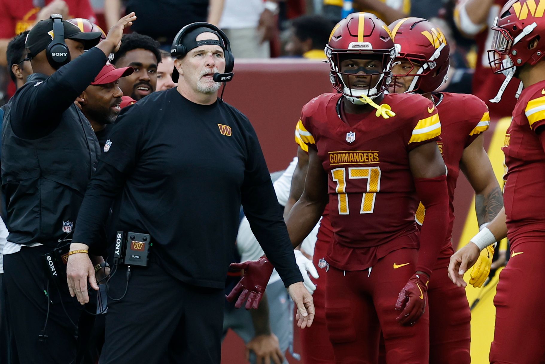 Washington Commanders head coach Dan Quinn (L) stands with Commanders wide receiver Terry McLaurin (17) on the sidelines against the Las Vegas Raiders during the third quarter at Northwest Stadium.