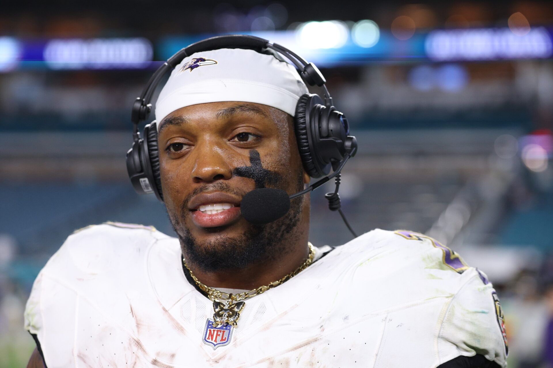 Baltimore Ravens running back Derrick Henry (22) wears a butterfly necklace during a postgame interview following a win over the Miami Dolphins at Hard Rock Stadium.