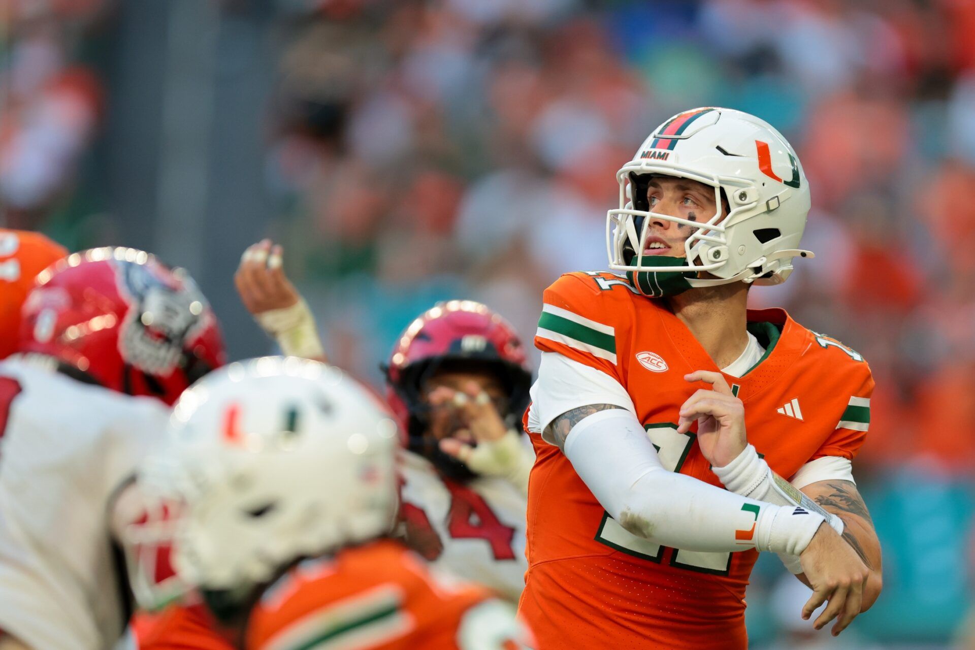 Miami Hurricanes quarterback Carson Beck (11) watches his pass against NC State Wolfpack during the second quarter at Hard Rock Stadium.