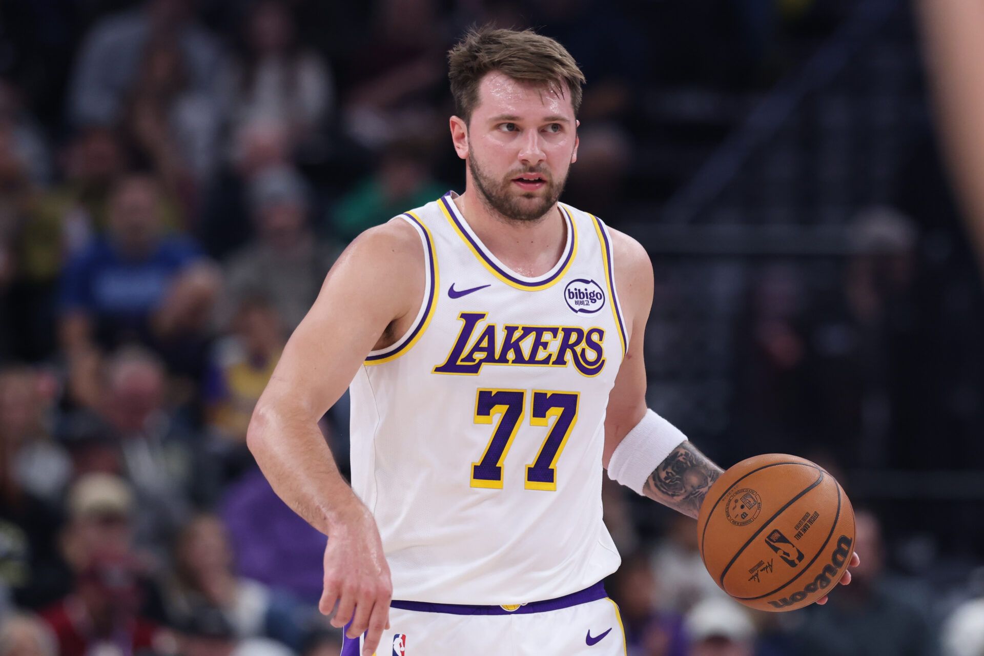 Los Angeles Lakers guard Luka Doncic (77) brings the ball up the court against the Utah Jazz during the first half at Delta Center.