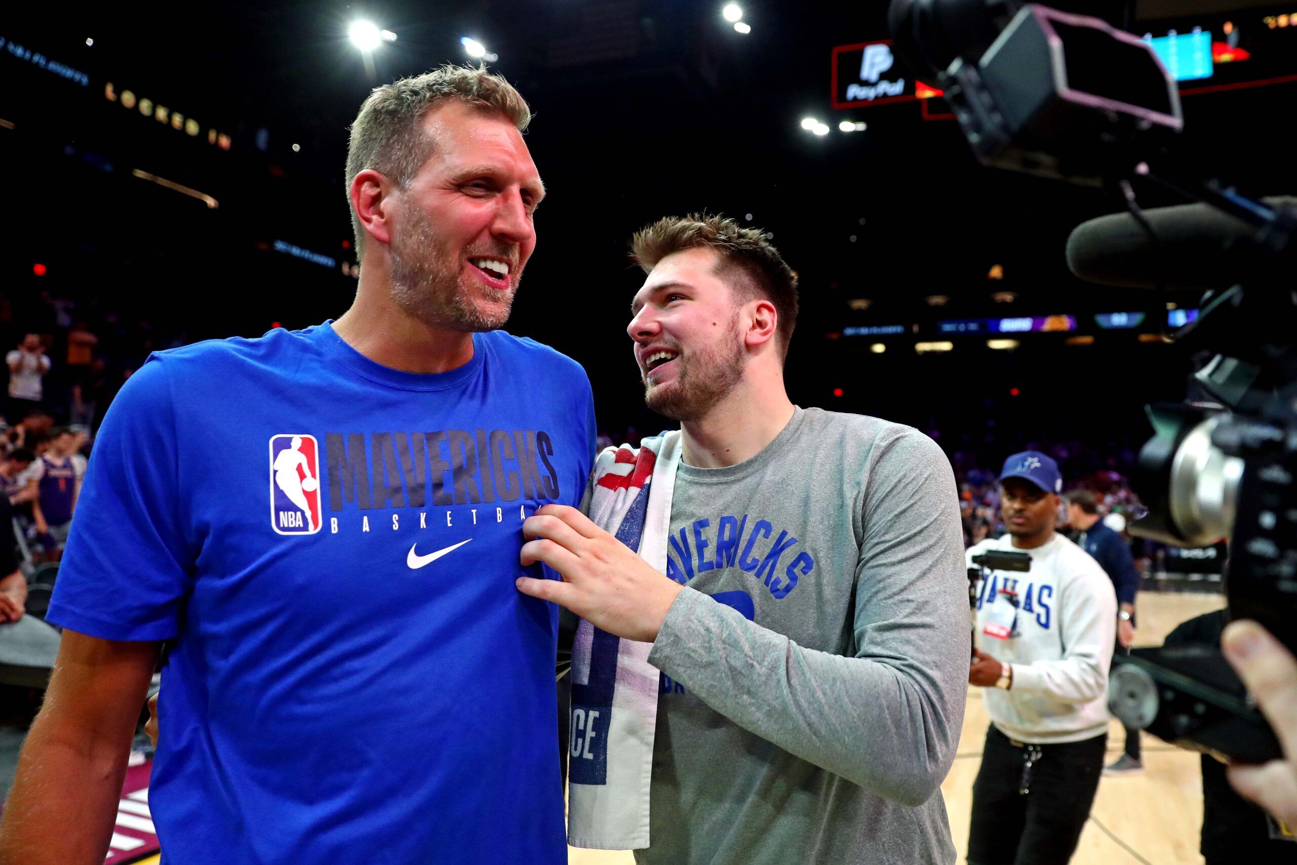 Dallas Mavericks guard Luka Doncic (77) greets former player Dirk Nowitzki after beating the Phoenix Suns in game seven of the second round for the 2022 NBA playoffs at Footprint Center.