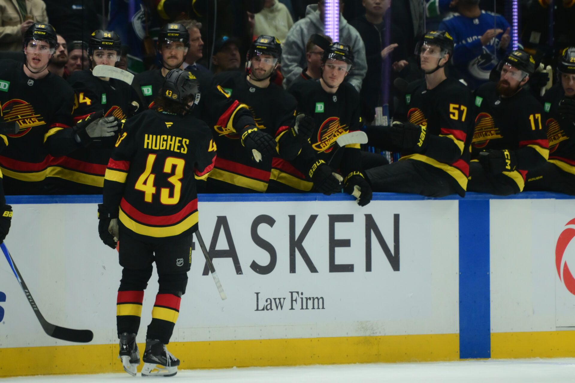 Vancouver Canucks defenseman Quinn Hughes (43) celebrates scoring with teammates on the bench during the third period against the Calgary Flames at Rogers Arena.