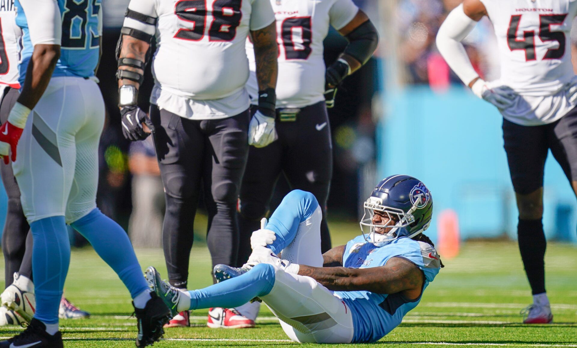 Tennessee Titans wide receiver Calvin Ridley (0) grabs his leg after the Titans offense’s first play of the game during the first quarter against the Houston Texans at Nissan Stadium in Nashville, Tenn., Sunday, Nov. 16, 2025.