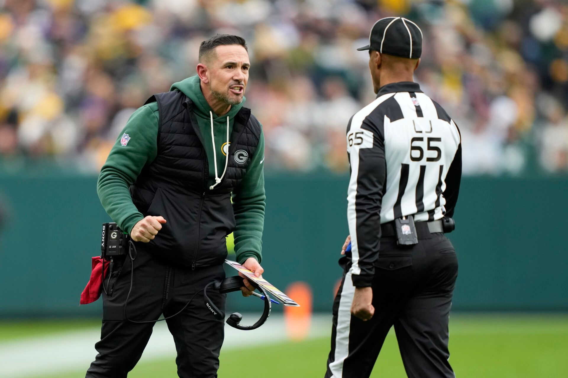 Green Bay Packers head coach Matt LaFleur talks with line judge Quentin Givens (65) during the first half against the Minnesota Vikings at Lambeau Field.