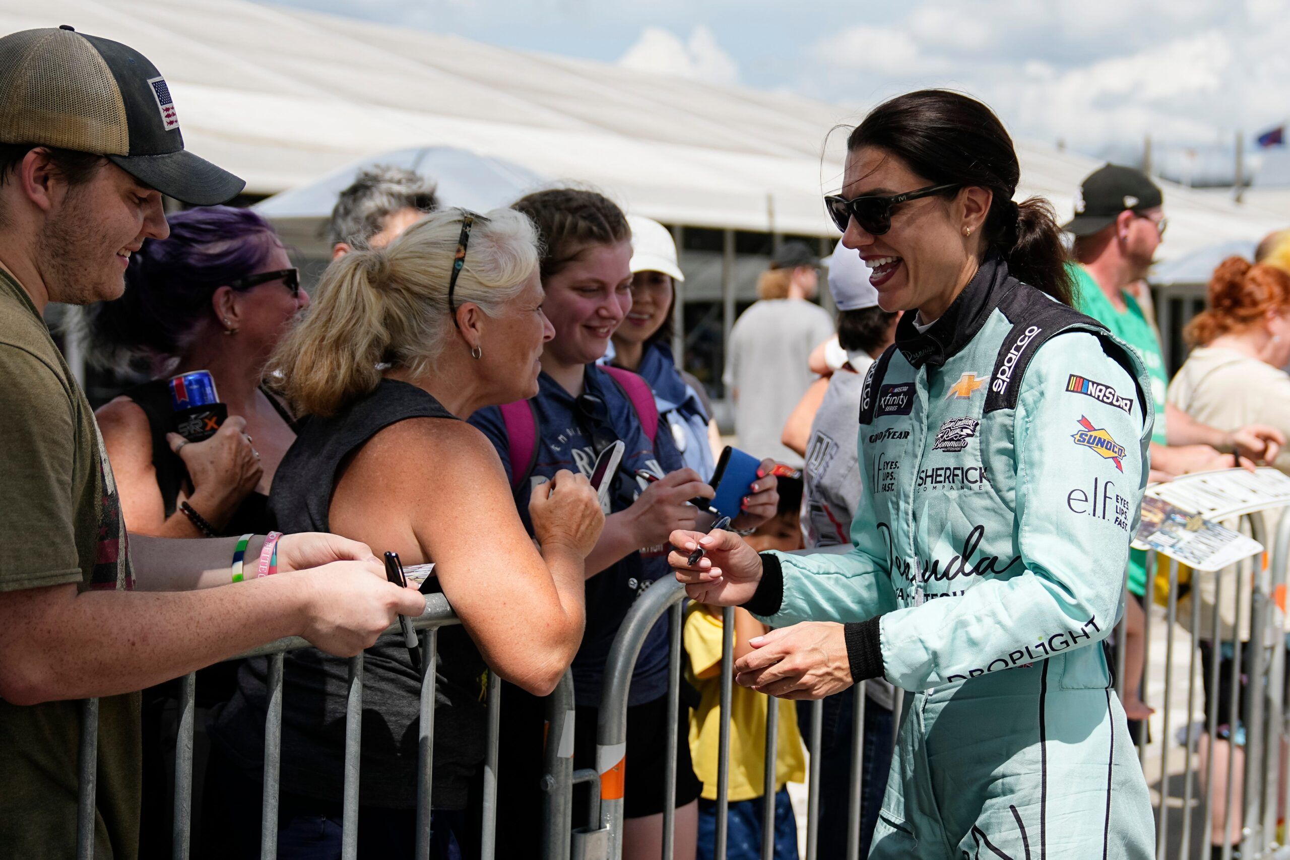 NASCAR Xfinity Series driver Katherine Legge (32) signs autographs with fans Saturday, July 26, 2025, prior to the Pennzoil 250 at Indianapolis Motor Speedway.