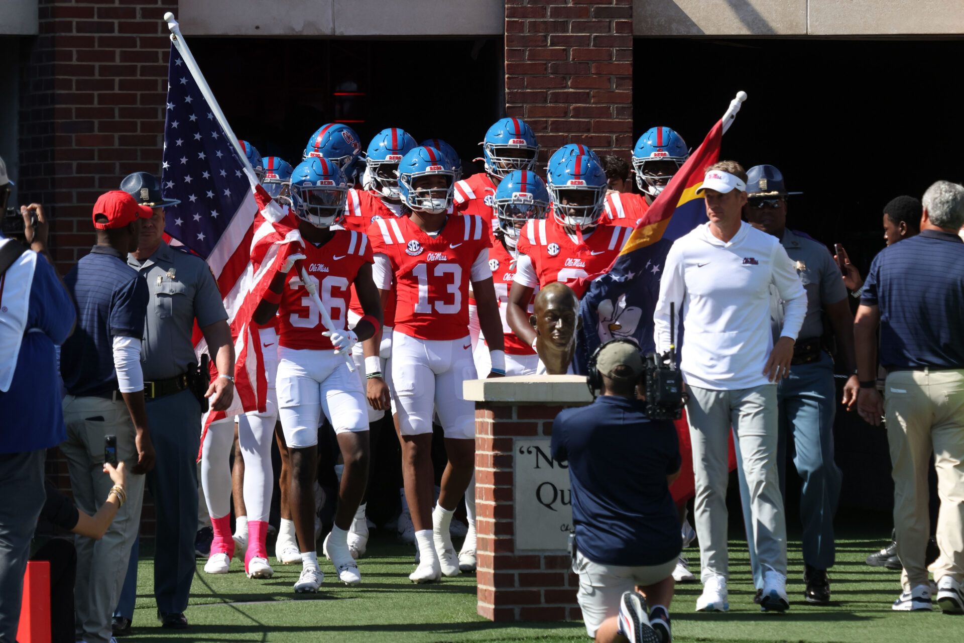 Mississippi Rebels head coach Lane Kiffin leads his team out of the tunnel prior to the game against the Washington State Cougars at Vaught-Hemingway Stadium.
