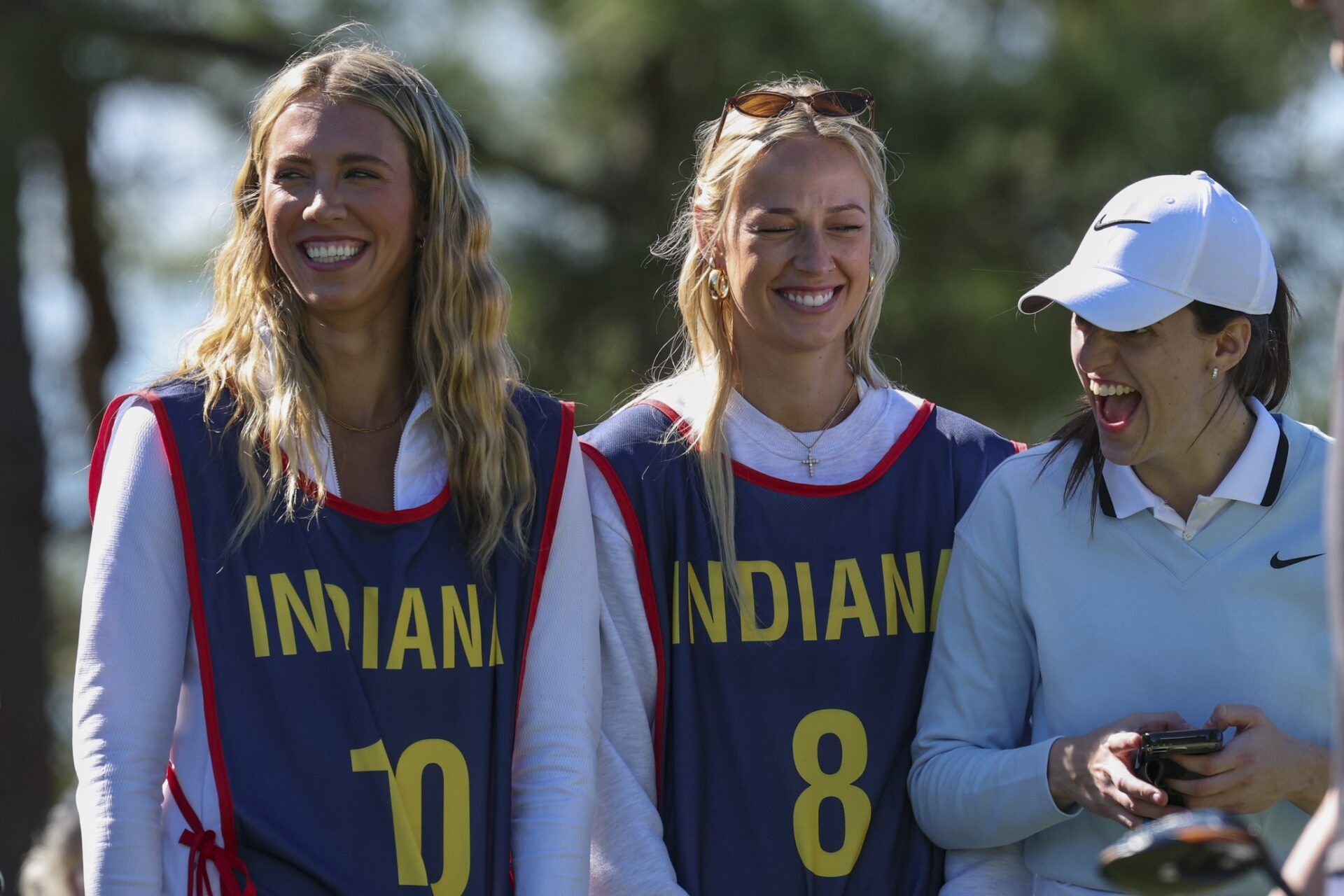 Indiana Fever guard Sophie Cunningham (8) and guard Lexie Hull (10) look on as guard Caitlin Clark (22) plays in the Annika Pro-Am golf tournament at Pelican Golf Club.