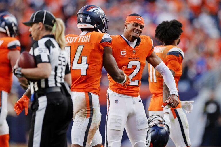 Denver Broncos wide receiver Courtland Sutton (14) and Denver Broncos cornerback Pat Surtain II (2) celebrate the win against the New York Giants at Empower Field at Mile High.