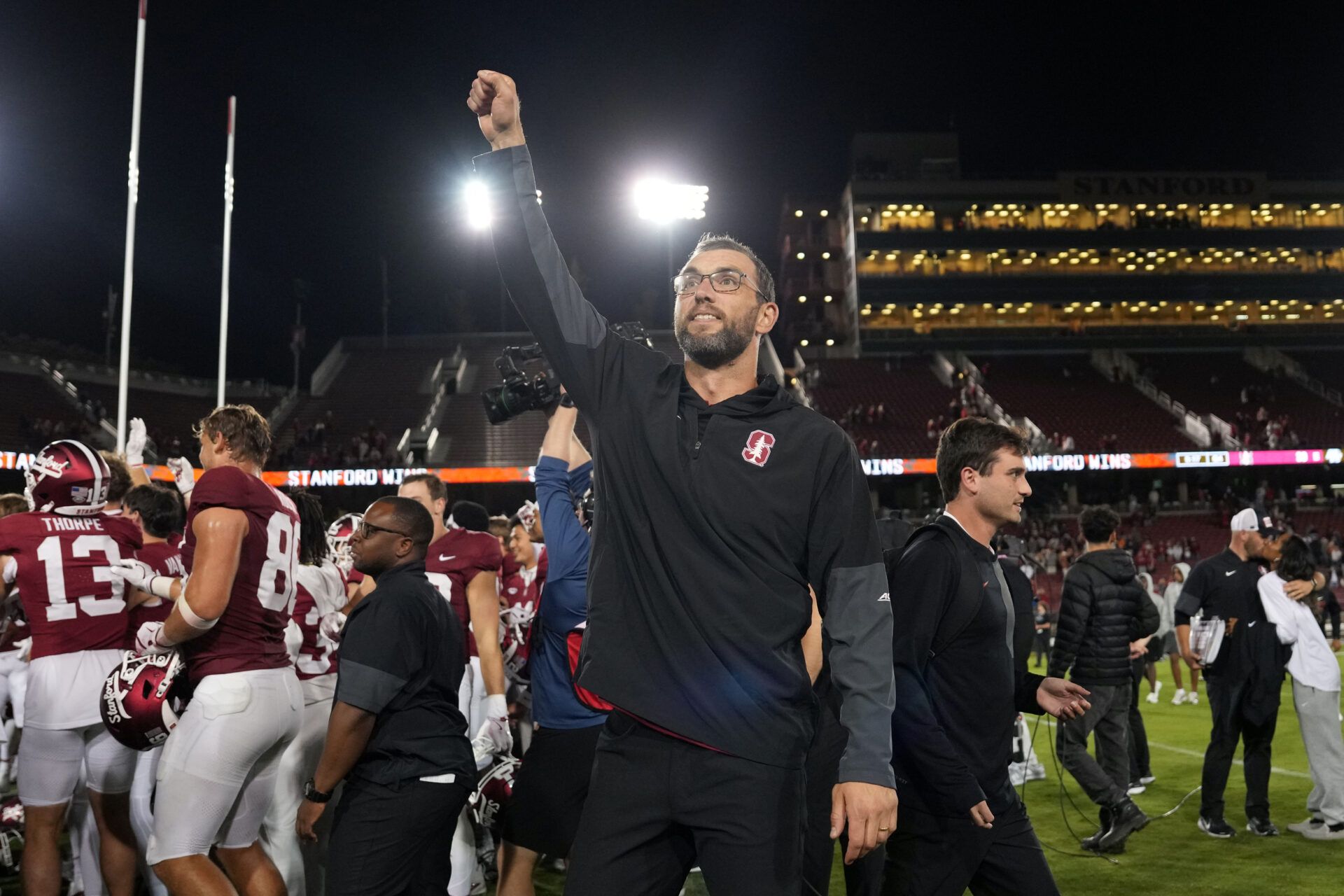 Stanford Cardinal general manager Andrew Luck (center) celebrates after defeating the Boston College Eagles at Stanford Stadium.