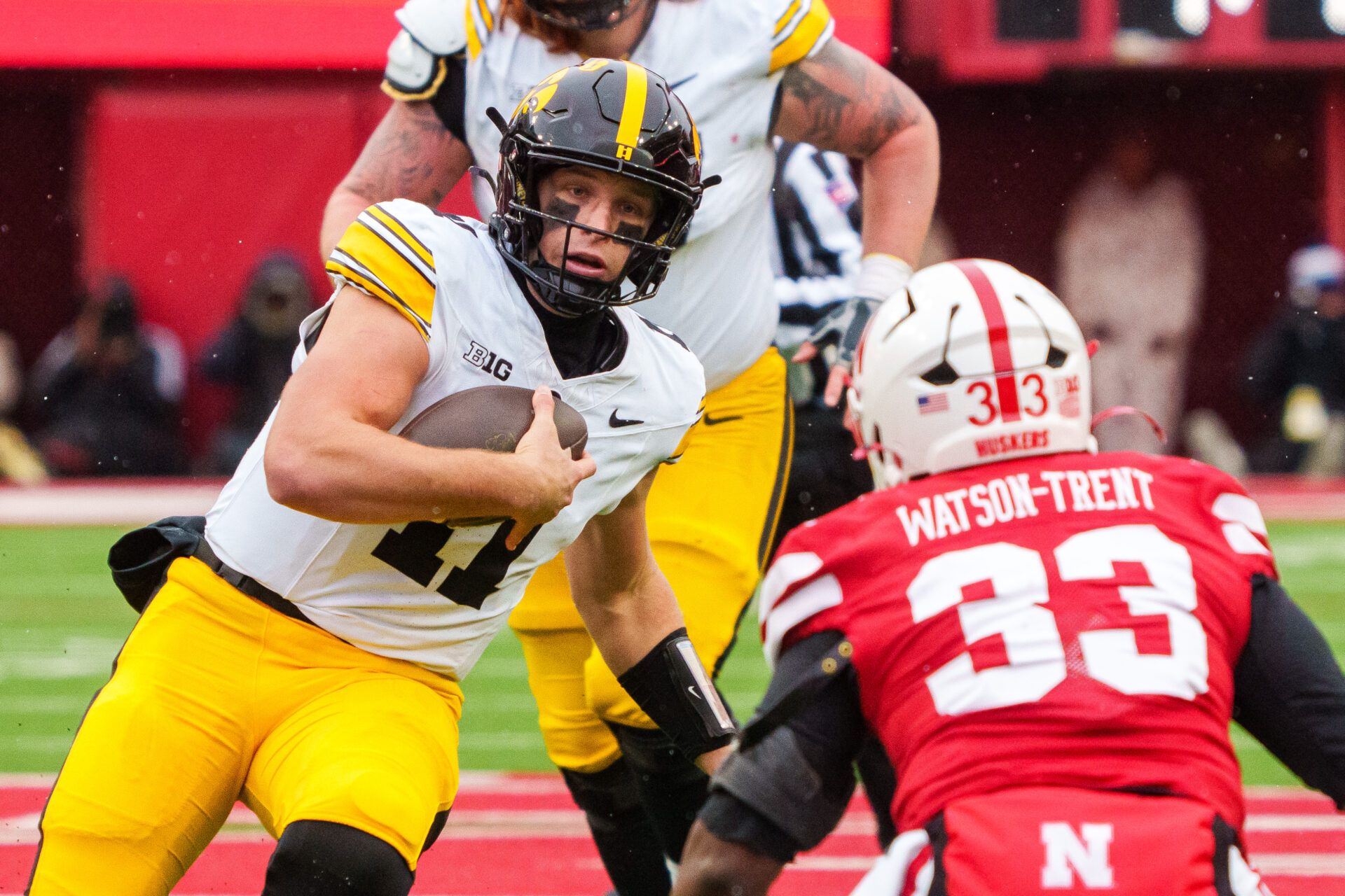 Iowa Hawkeyes quarterback Mark Gronowski (11) scrambles against Nebraska Cornhuskers linebacker Marques Watson-Trent (33) during the third quarter at Memorial Stadium.
