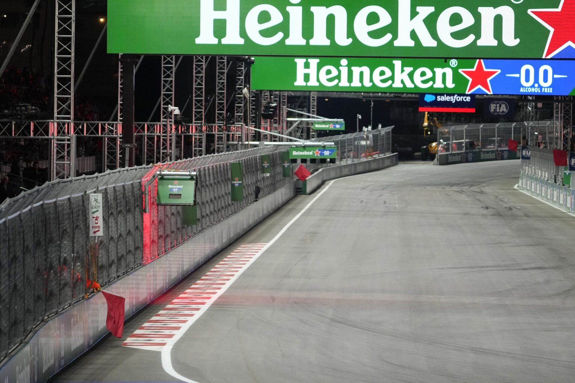 F1 track marshals wave a red flag during practice for the Formula 1 Heineken Silver Las Vegas Grand Prix 2025 at the Las Vegas Strip Circuit.