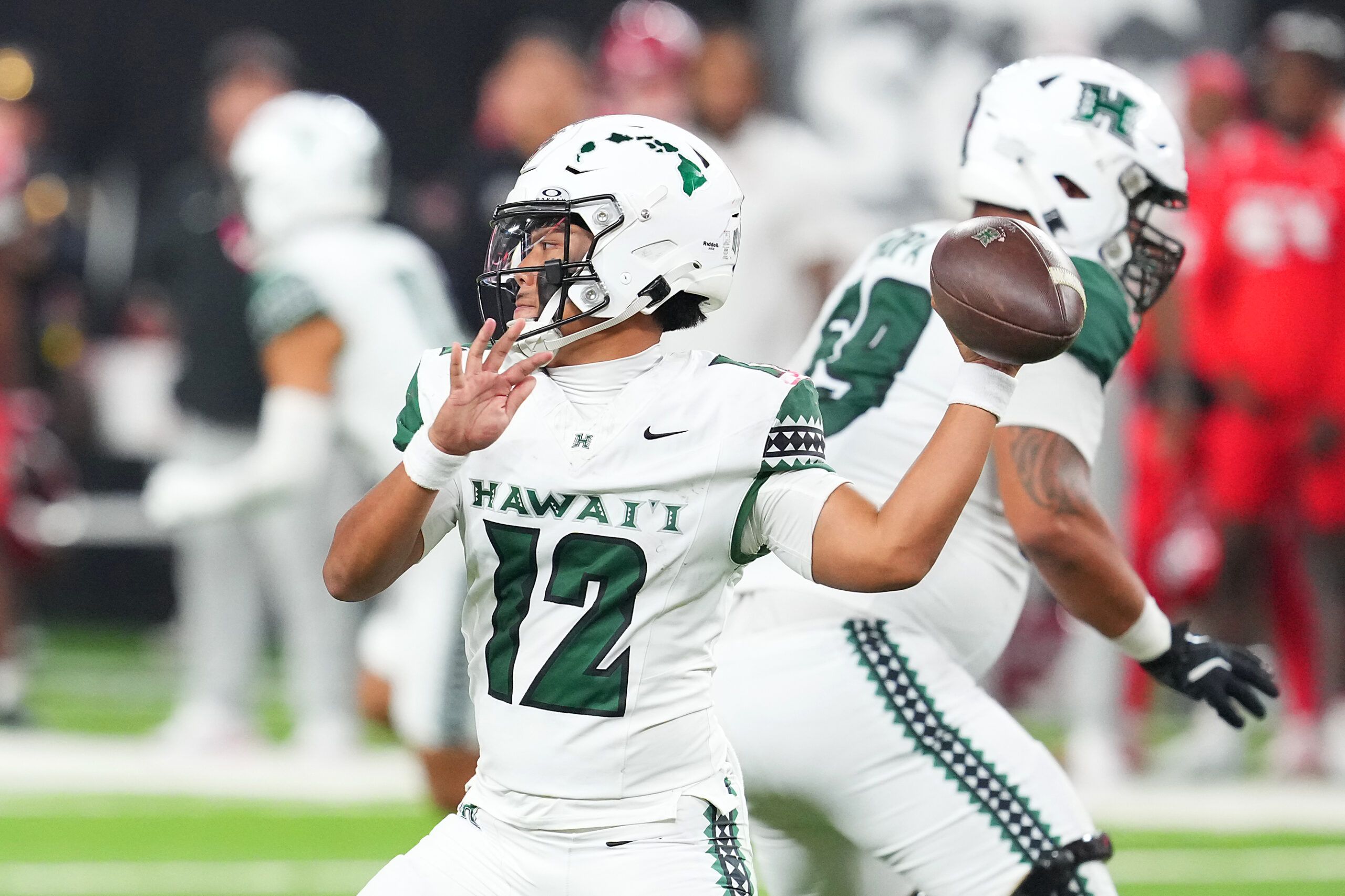 Hawaii Rainbow Warriors quarterback Micah Alejado (12) looks to make a pass against the UNLV Rebels during the fourth quarter at Allegiant Stadium.