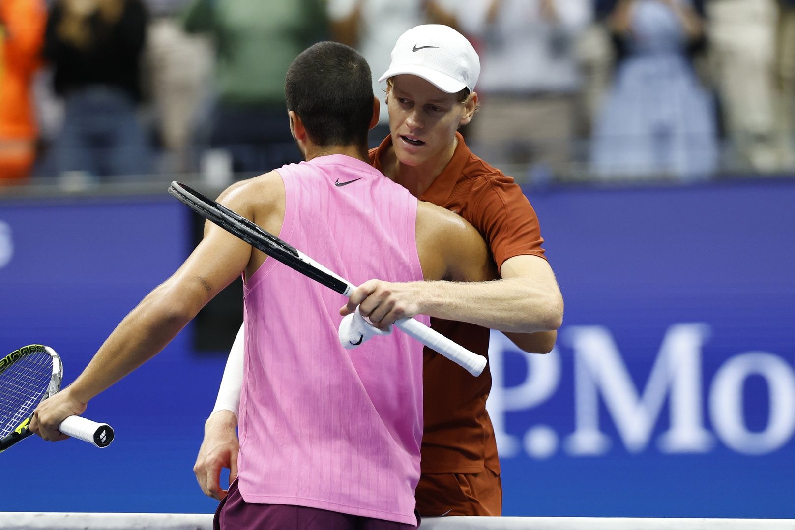 Carlos Alcaraz (ESP) (L) hugs Jannik Sinner (ITA) (R) at the net after their men's singles final of the 2025 US Open tennis championships at USTA Billie Jean King National Tennis Center.