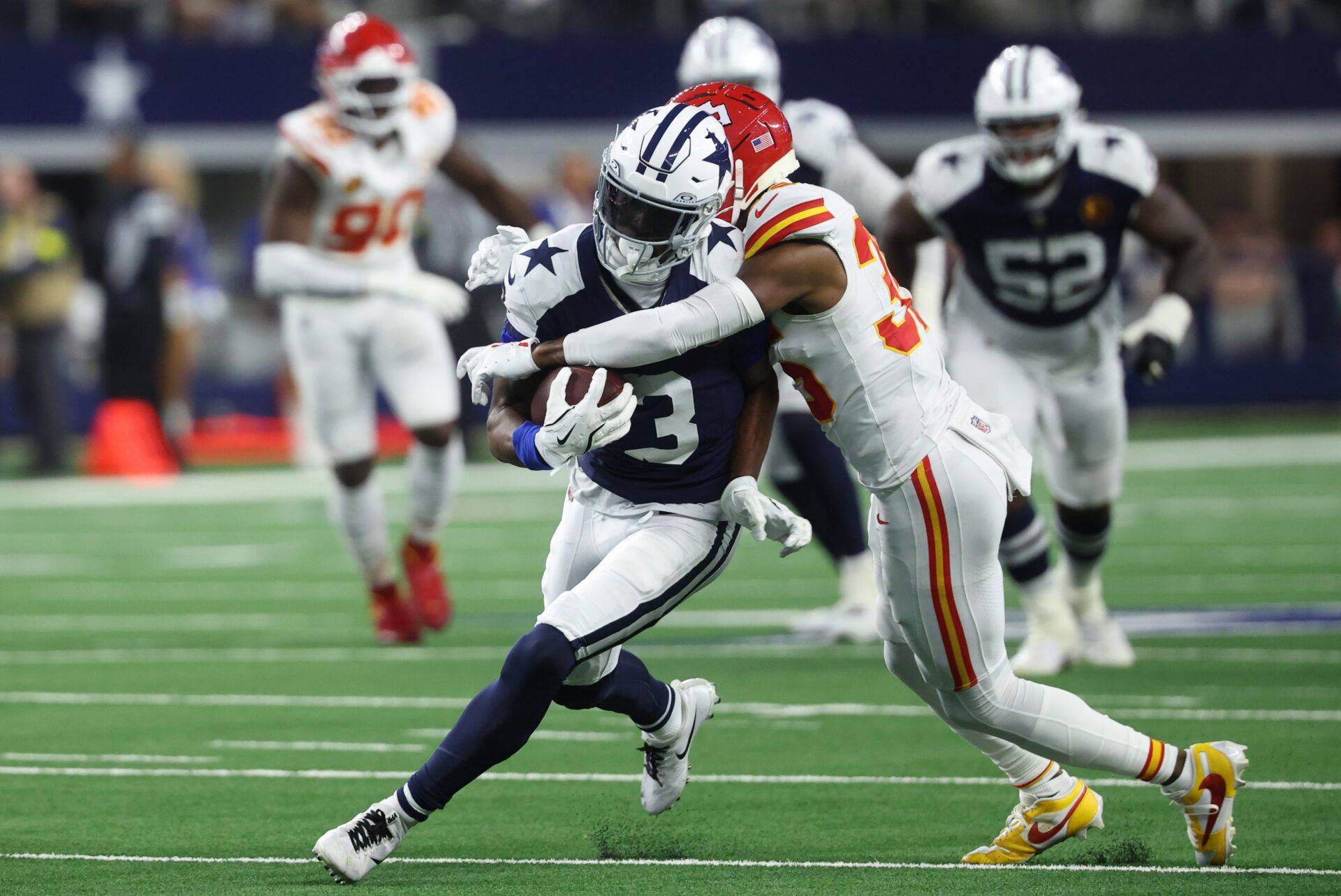 Dallas Cowboys wide receiver George Pickens (3) runs after a catch against Kansas City Chiefs cornerback Jaylen Watson (35) during the fourth quarter at AT&T Stadium.