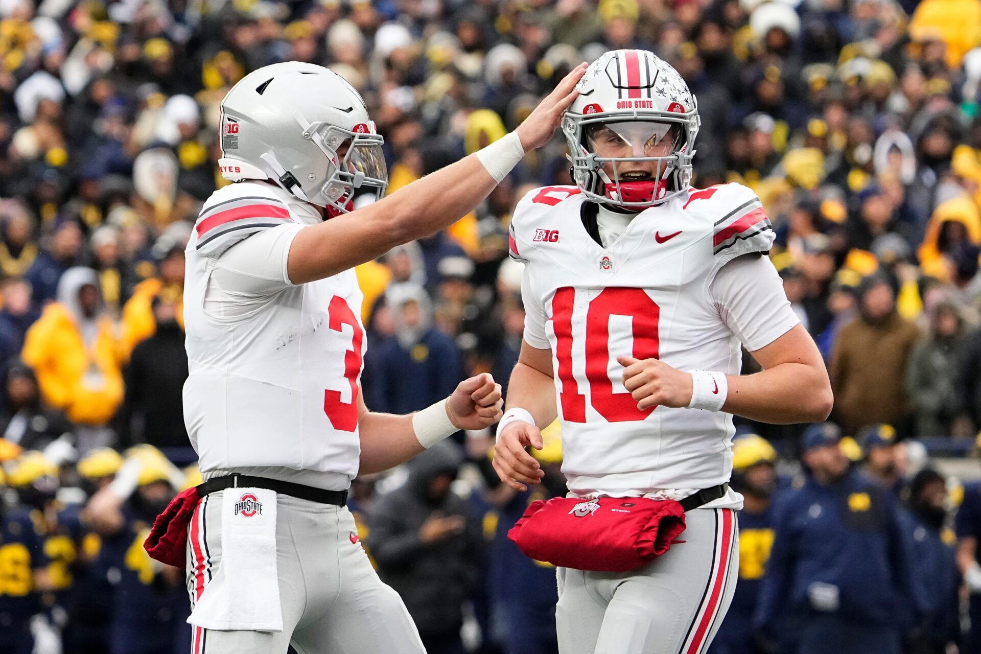Ohio State Buckeyes quarterback Lincoln Kienholz (3) celebrates with quarterback Julian Sayin (10) during the NCAA football game against the Michigan Wolverines at Michigan Stadium in Ann Arbor, Mich. on Nov. 29, 2025.