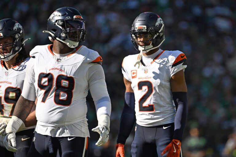 Denver Broncos defensive end John Franklin-Myers (98) and  cornerback Pat Surtain II (2) against the Philadelphia Eagles at Lincoln Financial Field.