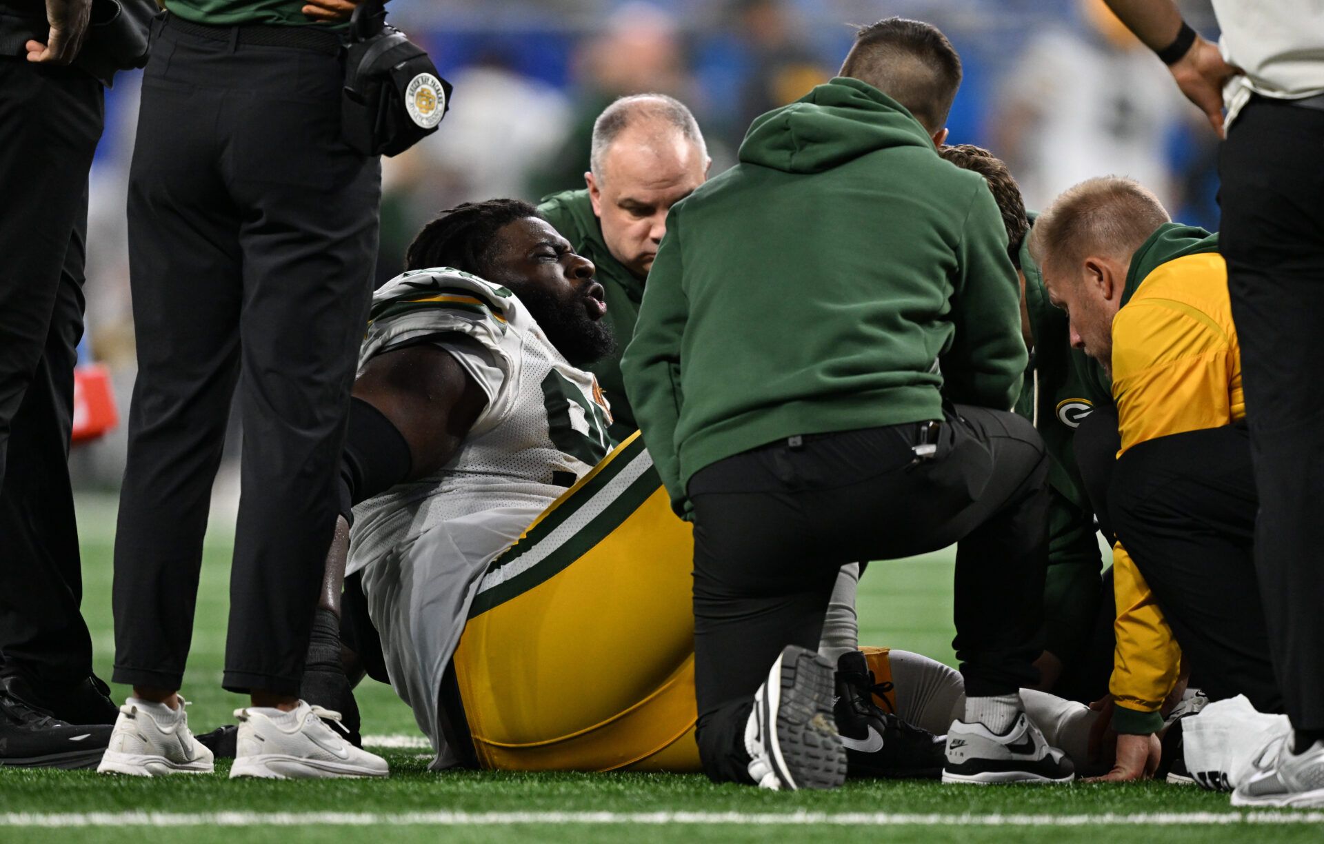 Green Bay Packers defensive tackle Devonte Wyatt (95) is looked at after an injury against the Detroit Lions during the third quarter at Ford Field.