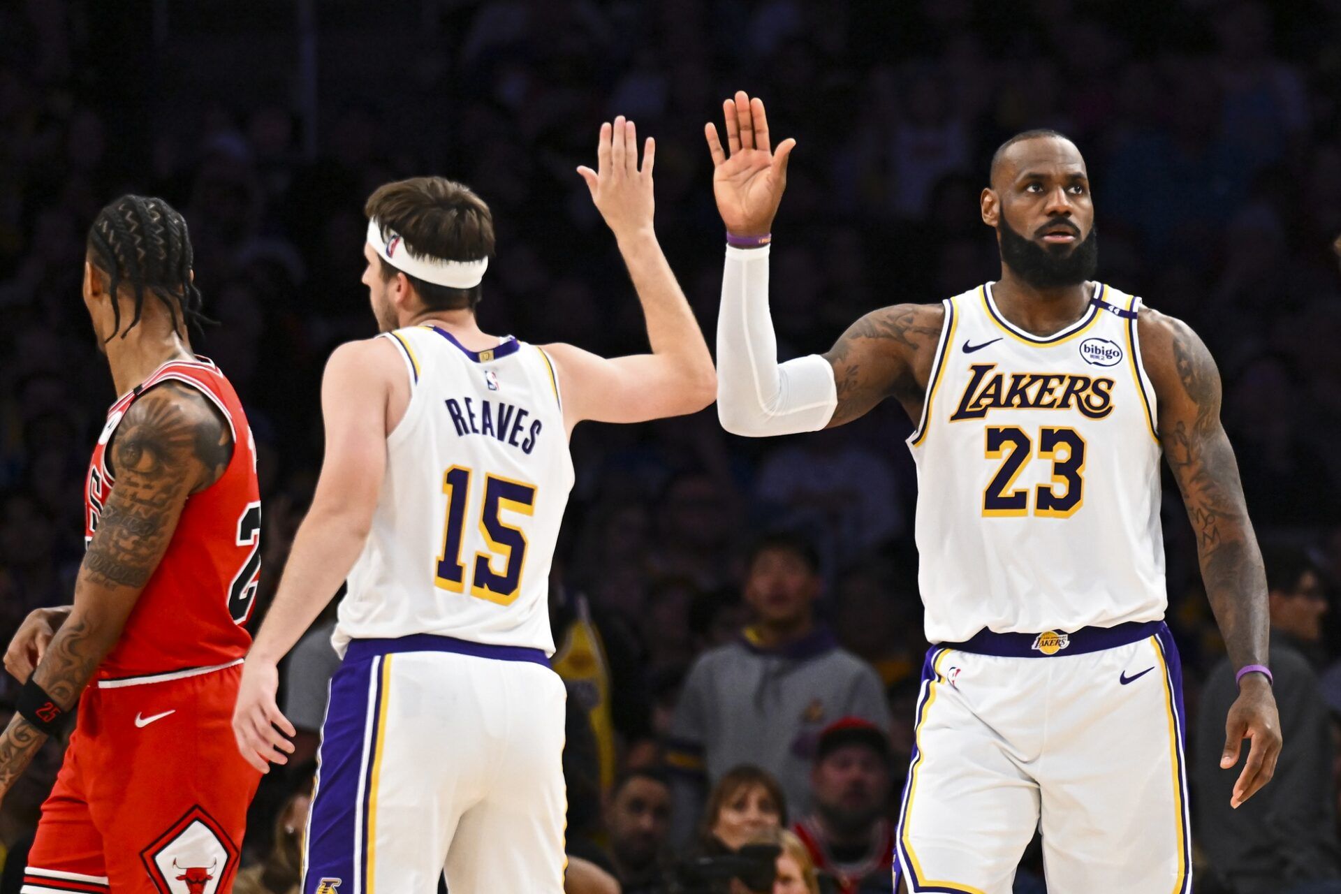 Los Angeles Lakers forward LeBron James (23) fives guard Austin Reaves (15) after scoring against the Chicago Bulls during the second half at Crypto.com Arena.