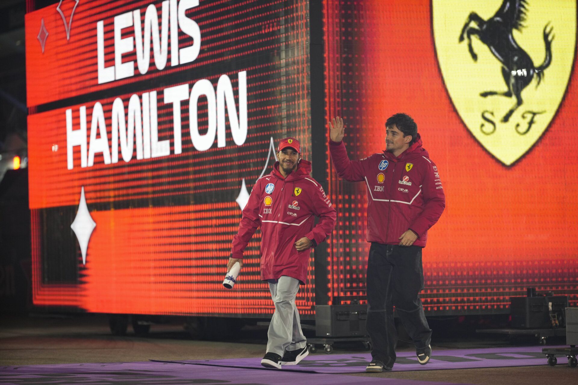 Ferrari driver Lewis Hamilton (44), left, and Ferrari driver Charles Leclerc (16) arrive for the Las Vegas Grand Prix drivers parade at the Las Vegas Strip Circuit.