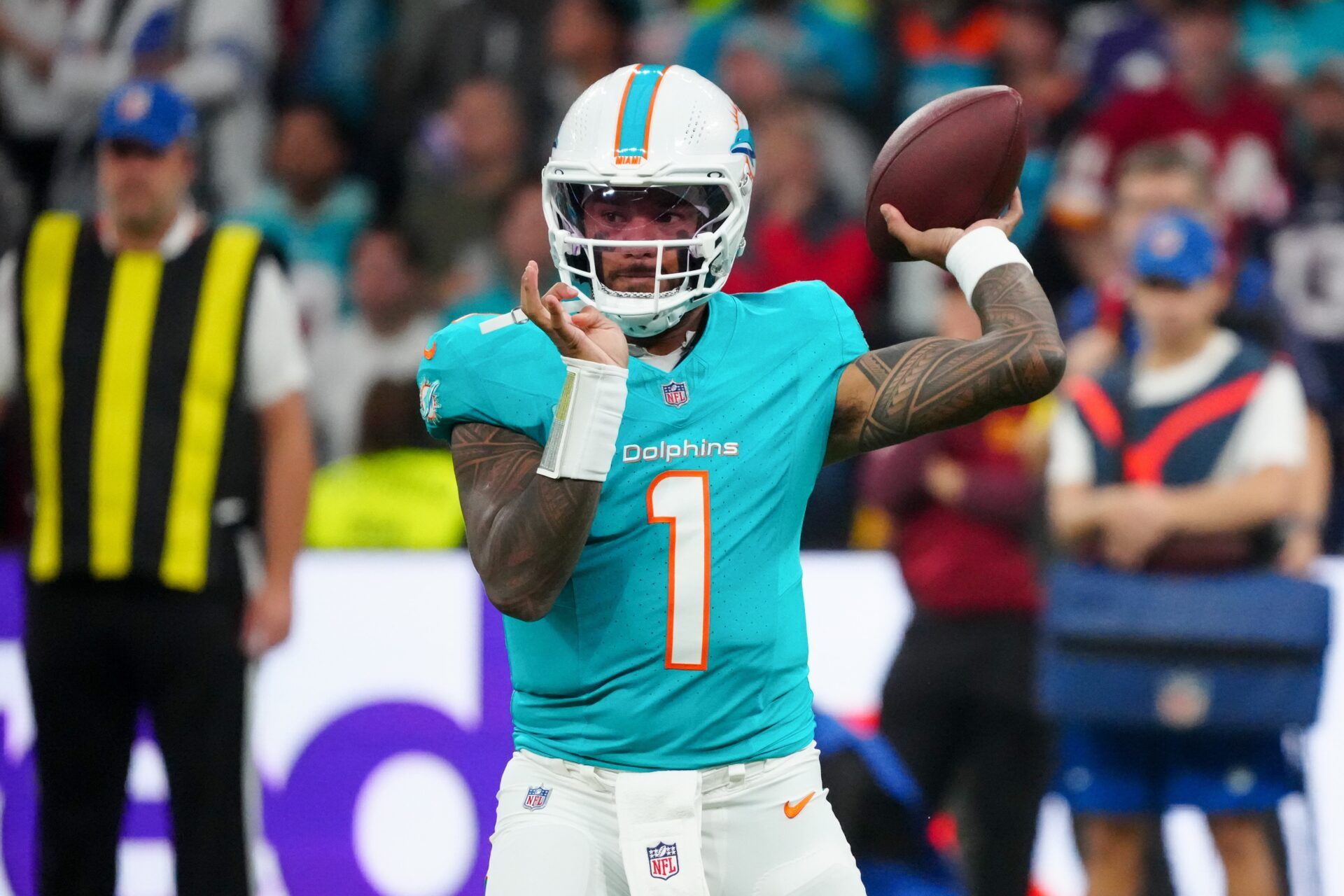 Miami Dolphins quarterback Tua Tagovailoa (1) passes the ball against the Washington Commanders in the first quarter during the 2025 NFL Madrid Game at Santiago Bernabeu Stadium.