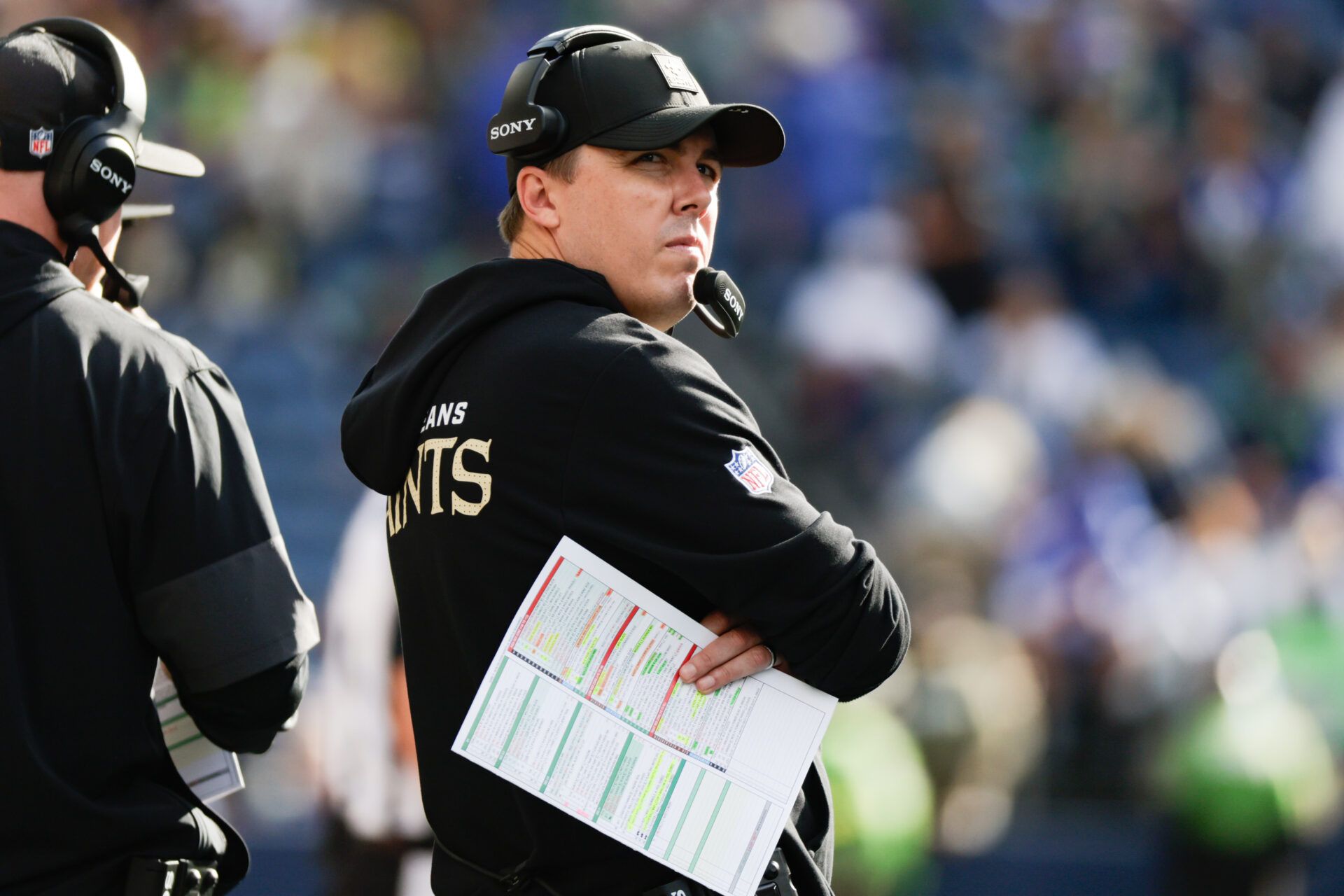 New Orleans Saints head coach Kellen Moore looks at the scoreboard during the second half against the Seattle Seahawks at Lumen Field.