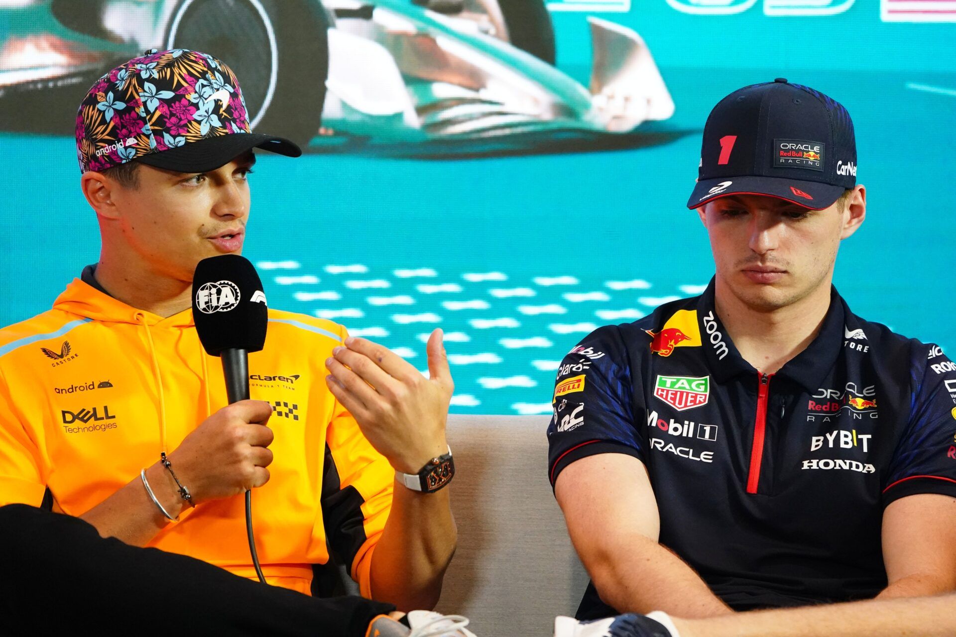 McLaren driver Lando Norris (4) of Great Britain and  Red Bull driver Max Verstappen (1) of the Netherlands talk with the media during a breakout media session at Miami International Autodrome.
