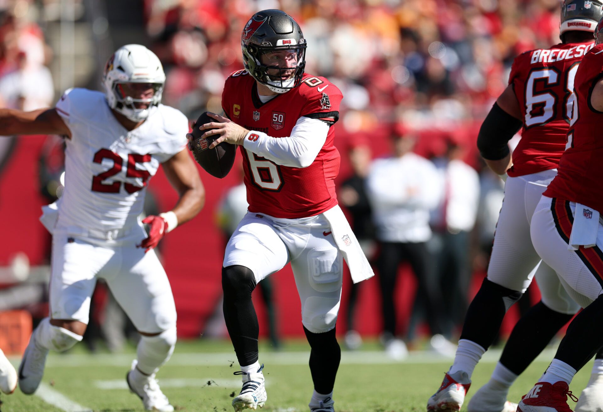 Tampa Bay Buccaneers quarterback Baker Mayfield (6) scrambles during the first half against the Arizona Cardinals at Raymond James Stadium.
