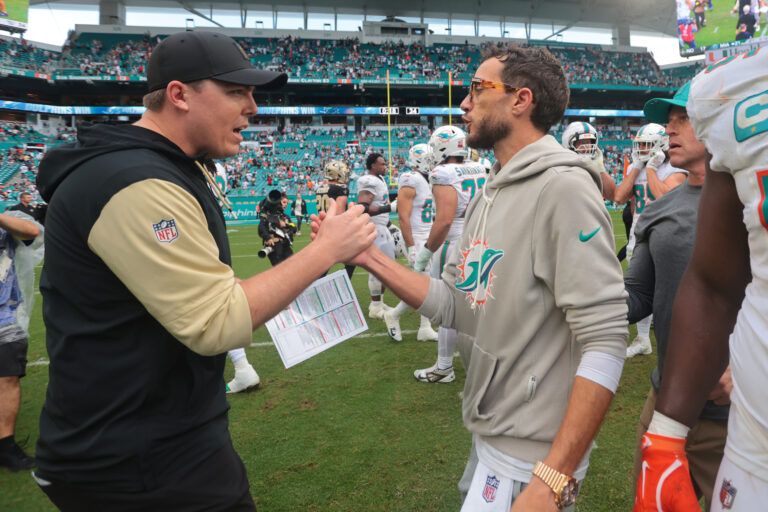 New Orleans Saints head coach Kellen Moore and Miami Dolphins head coach Mike McDaniel shake hands following a game at Hard Rock Stadium.