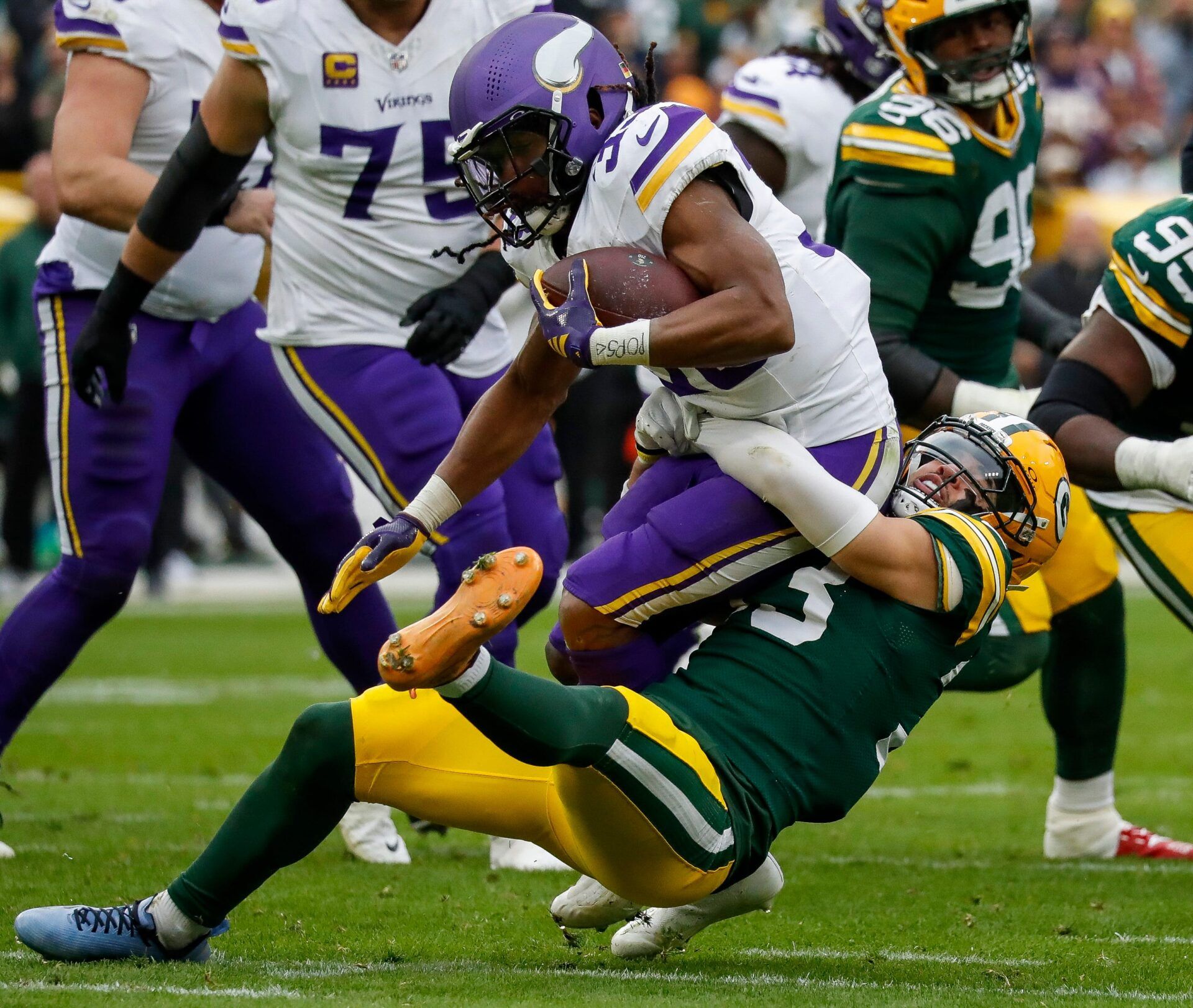 Green Bay Packers safety Evan Williams (bottom) tackles Minnesota Vikings running back Aaron Jones Sr. (top) for a loss on Sunday, November 23, 2025, at Lambeau Field in Green Bay, Wis. The Packers won the game, 23-6.
Tork Mason/USA TODAY NETWORK-Wisconsin