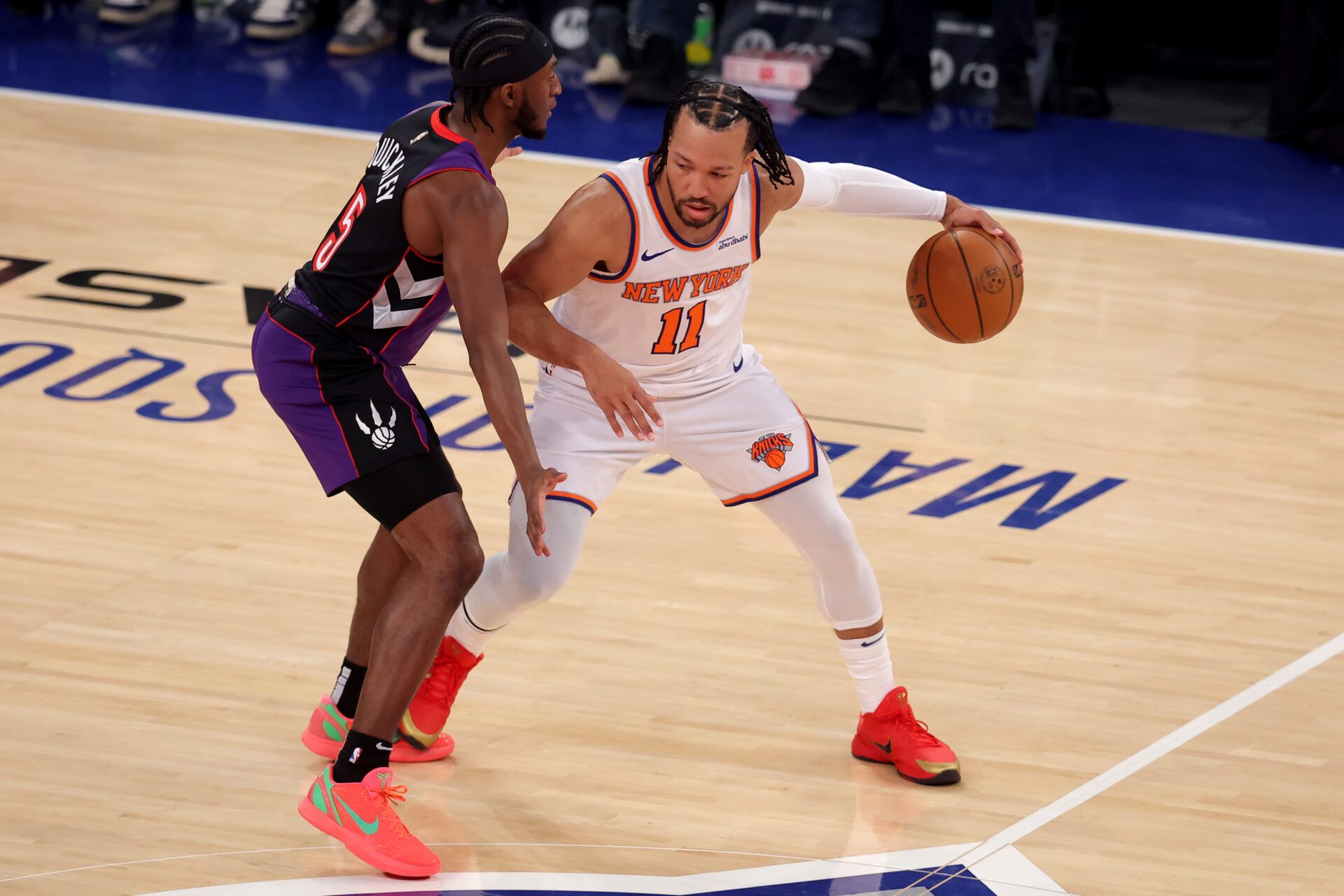 New York Knicks guard Jalen Brunson (11) controls the ball against Toronto Raptors guard Immanuel Quickley (5) during the first quarter at Madison Square Garden.