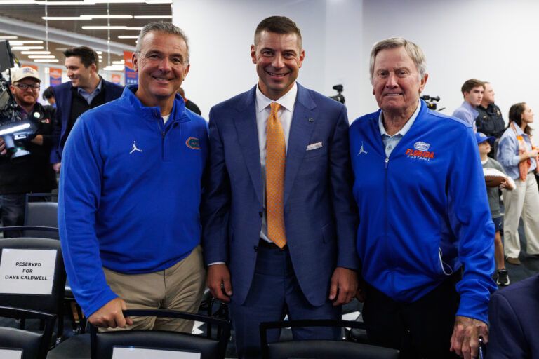 Florida Gators former head coach Urban Meyer, Florida Gators head coach Jon Sumrall, and Florida Gators former head coach Steve Spurrier pose after the press conference at the Heavener Football Training Center at the University of Florida.