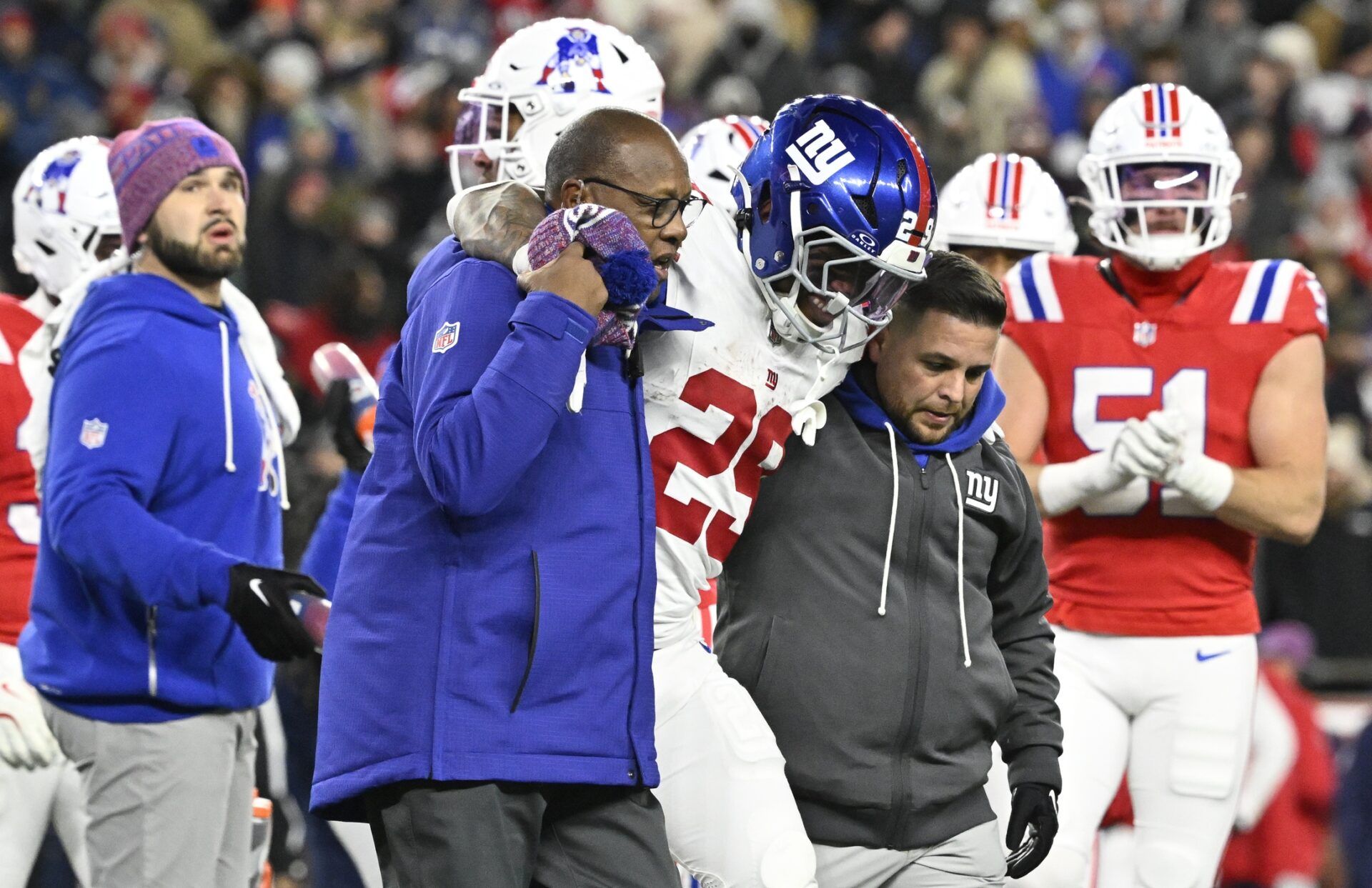 New York Giants running back Tyrone Tracy Jr. (29) is helped off the field during the fourth quarter against the New England Patriots at Gillette Stadium.