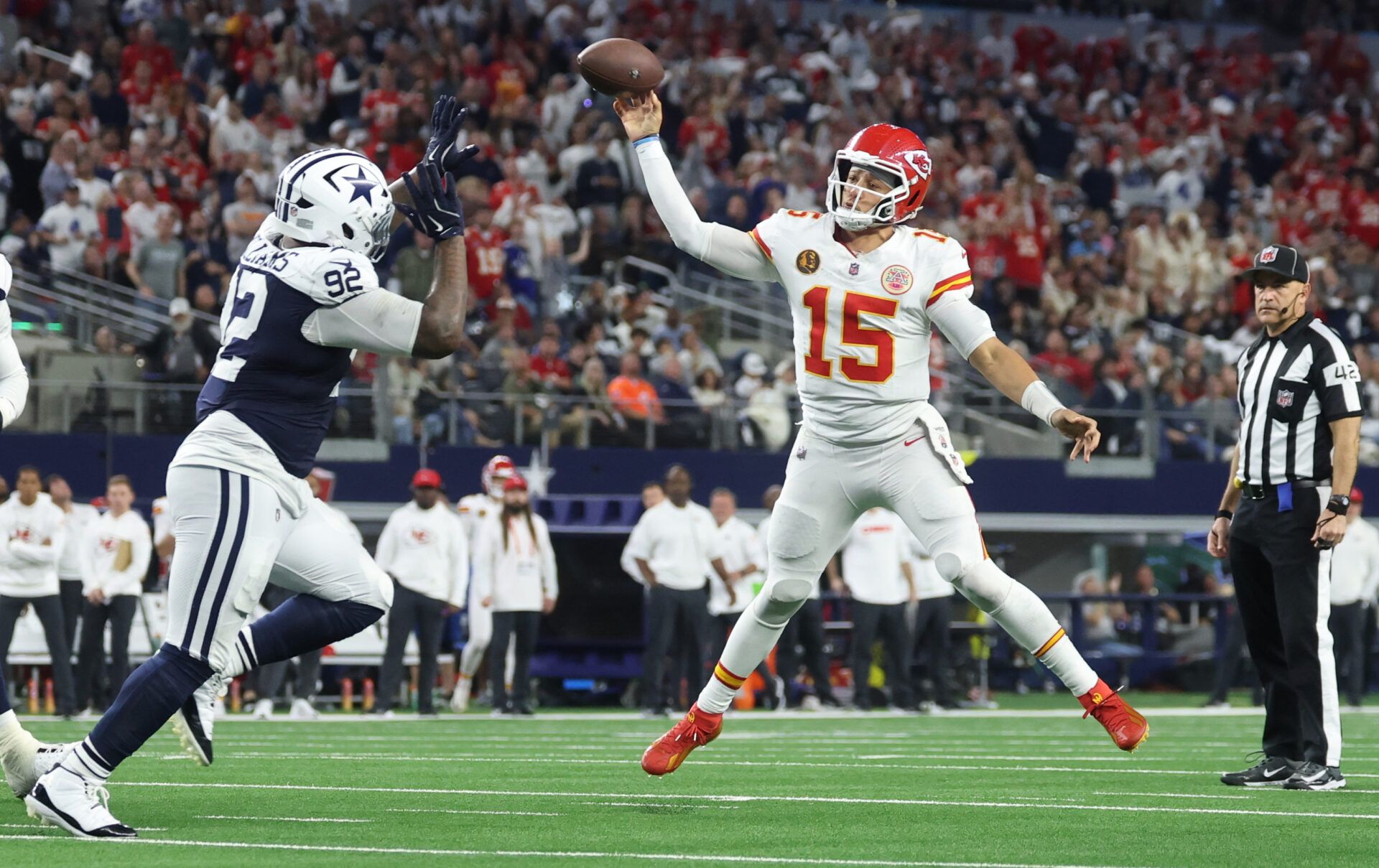 Kansas City Chiefs quarterback Patrick Mahomes (15) throws a pass for a touchdown against Dallas Cowboys defensive tackle Quinnen Williams (92) during the fourth quarter at AT&T Stadium.