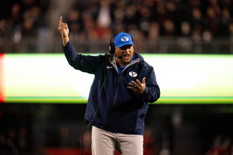 BYU Cougars head coach Kalani Sitake coaches in the fourth quarter of the NCAA football game between the Cincinnati Bearcats and BYU Cougars at Nippert Stadium in Cincinnati on Nov. 22, 2025.