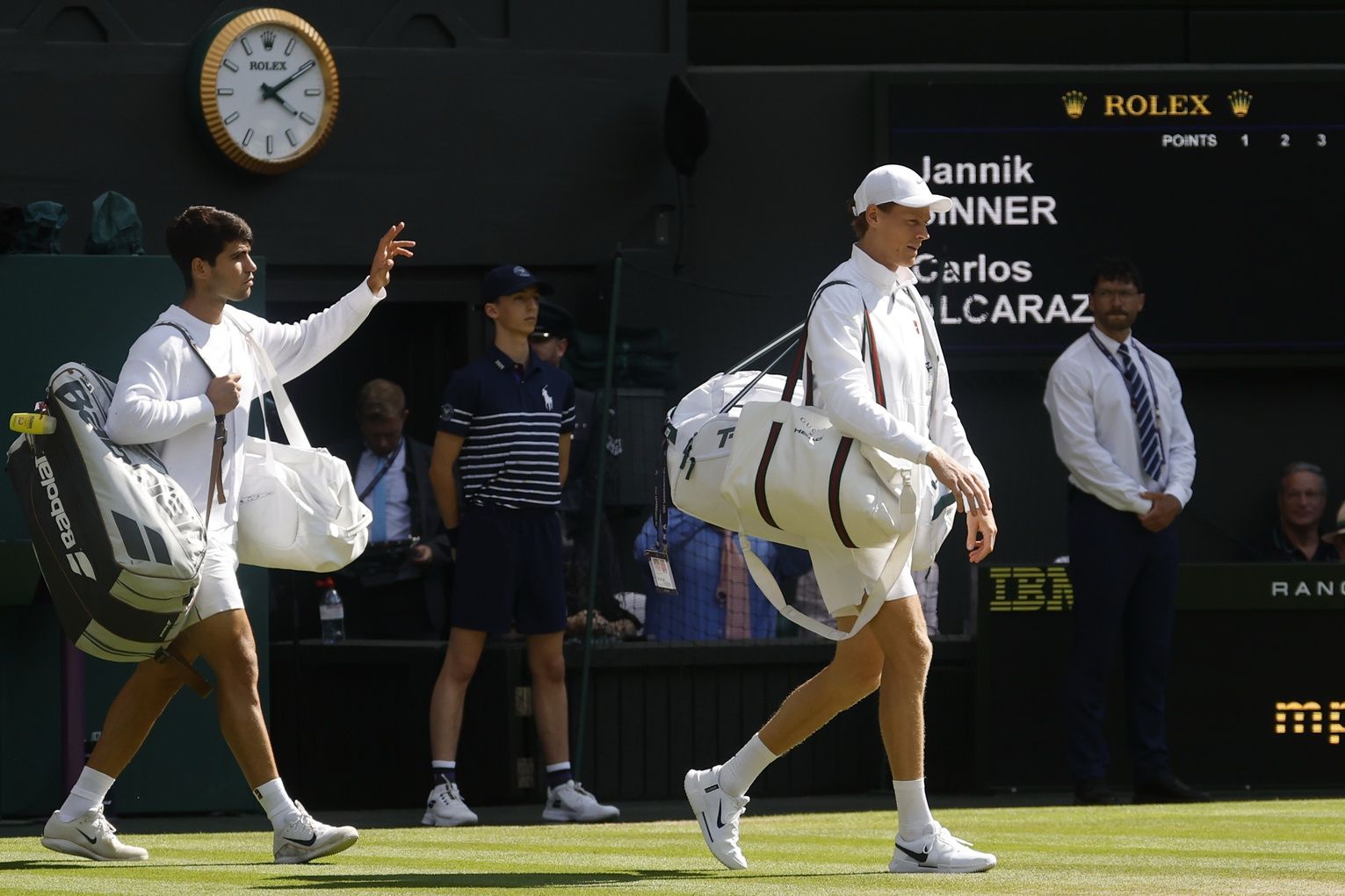 (L-R) Carlos Alcaraz (ESP) and Jannik Sinner (ITA) walk onto Centre Court prior to their gentlemen's' singles final of The Championships Wimbledon 2025 at All England Lawn Tennis and Croquet Club.