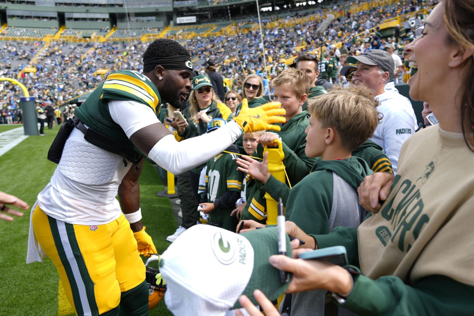 Green Bay Packers wide receiver Jayden Reed (11) signs autographs before the game against the Detroit Lions at Lambeau Field.