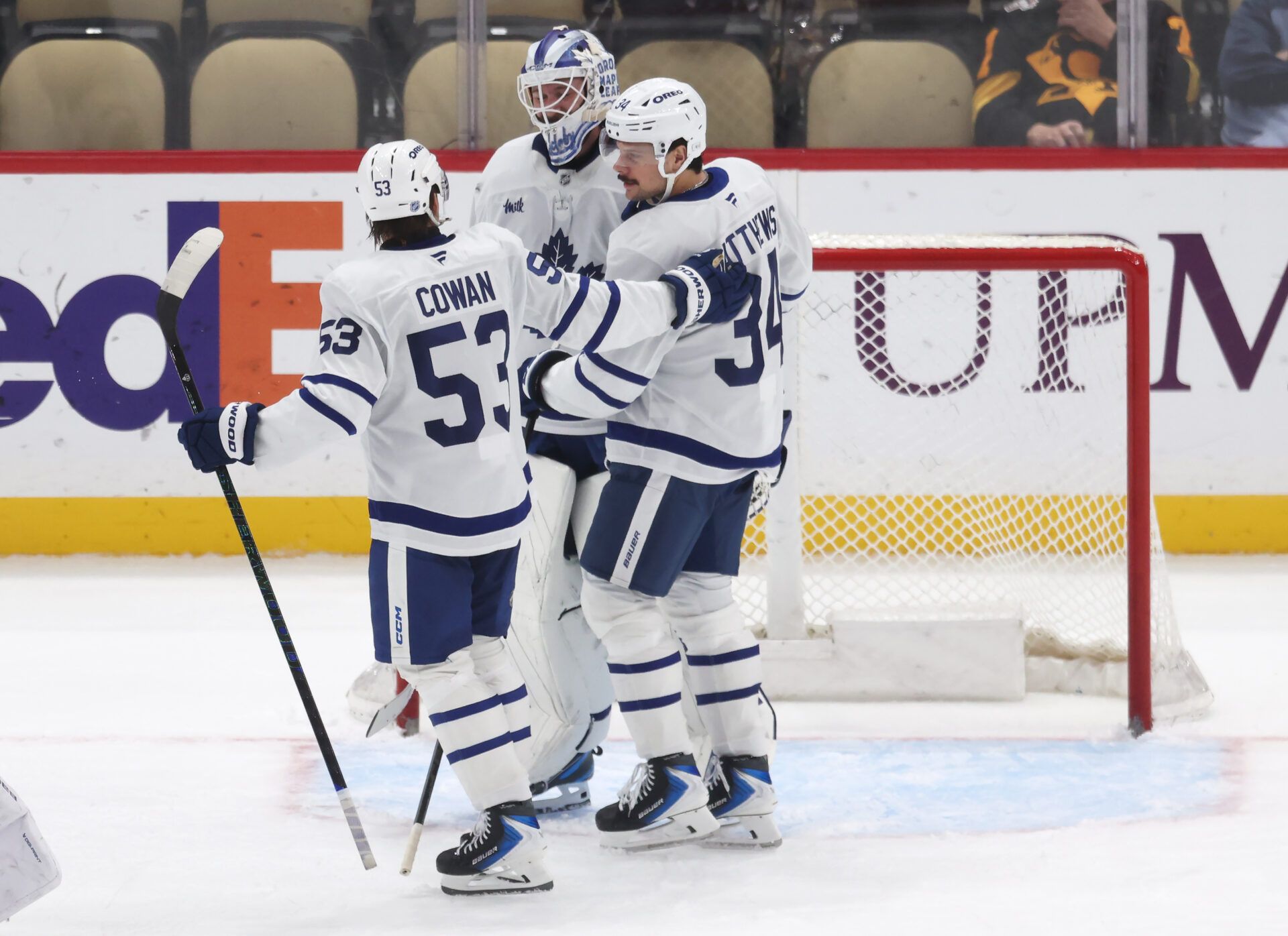 Toronto Maple Leafs right wing Easton Cowan (53) and goaltender Dennis Hildeby (35) and center Auston Matthews (34) celebrate after defeating the Pittsburgh Penguins at PPG Paints Arena.