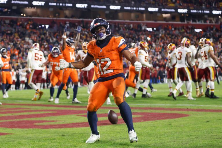 Denver Broncos running back RJ Harvey (12) celebrates after scoring a touchdown against the Washington Commanders in overtime of the game at Northwest Stadium.