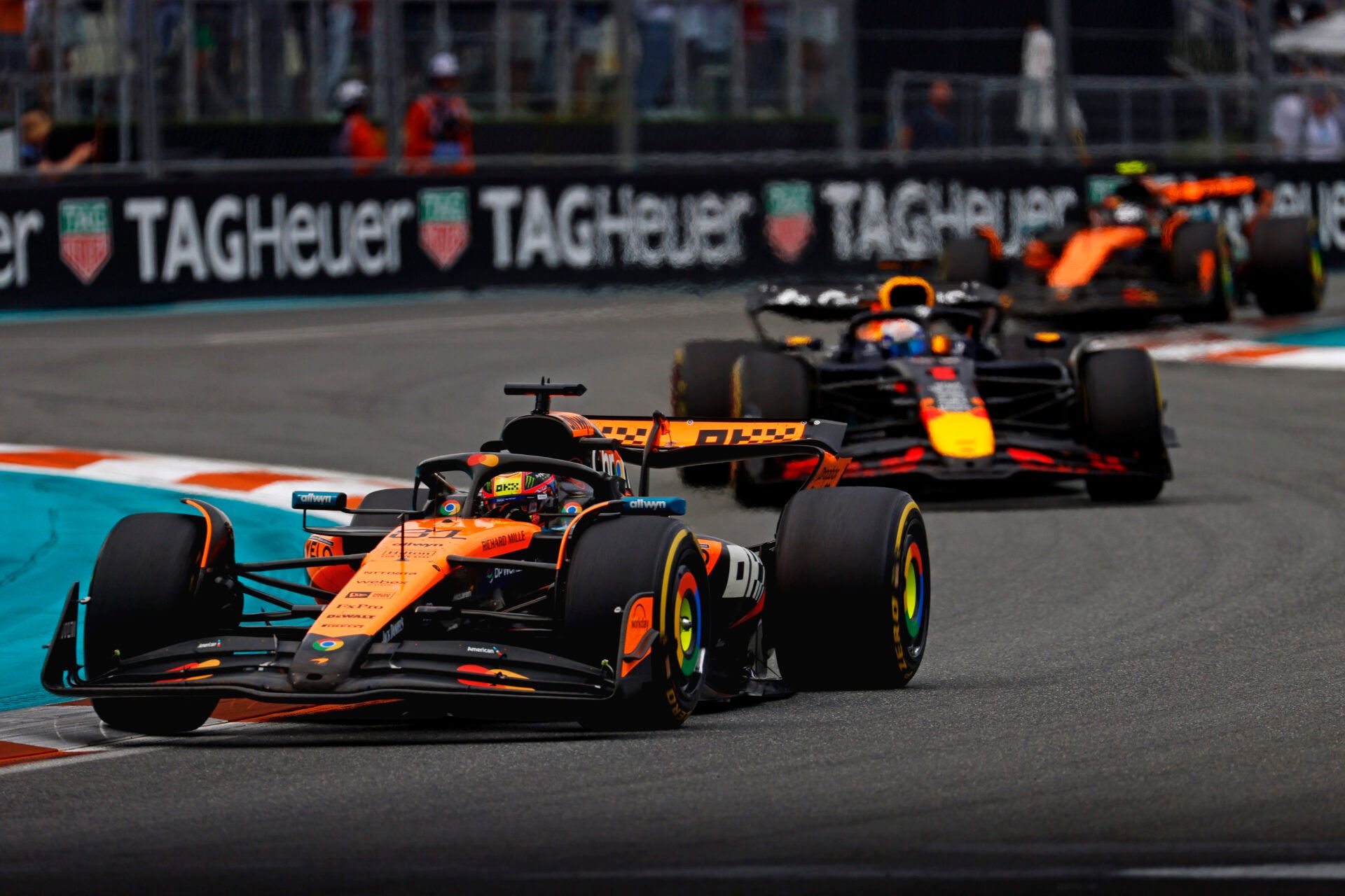 2025; Miami Gardens, FL, USA;  McLaren driver Oscar Piastri (81) leads Red Bull driver Max Verstappen (1) and McLaren driver Lando Norris (4) during the F1 Miami Grand Prix at Miami International Autodrome.