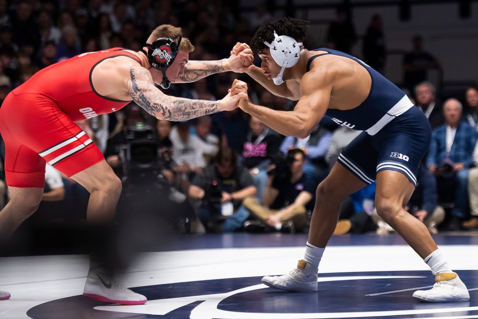 Ohio State's Rocco Welsh, left, wrestles Penn State’s Carter Starocci in their 174-pound bout on Feb. 2, 2024, in State College, Pa. The Nittany Lions won, 28-9.