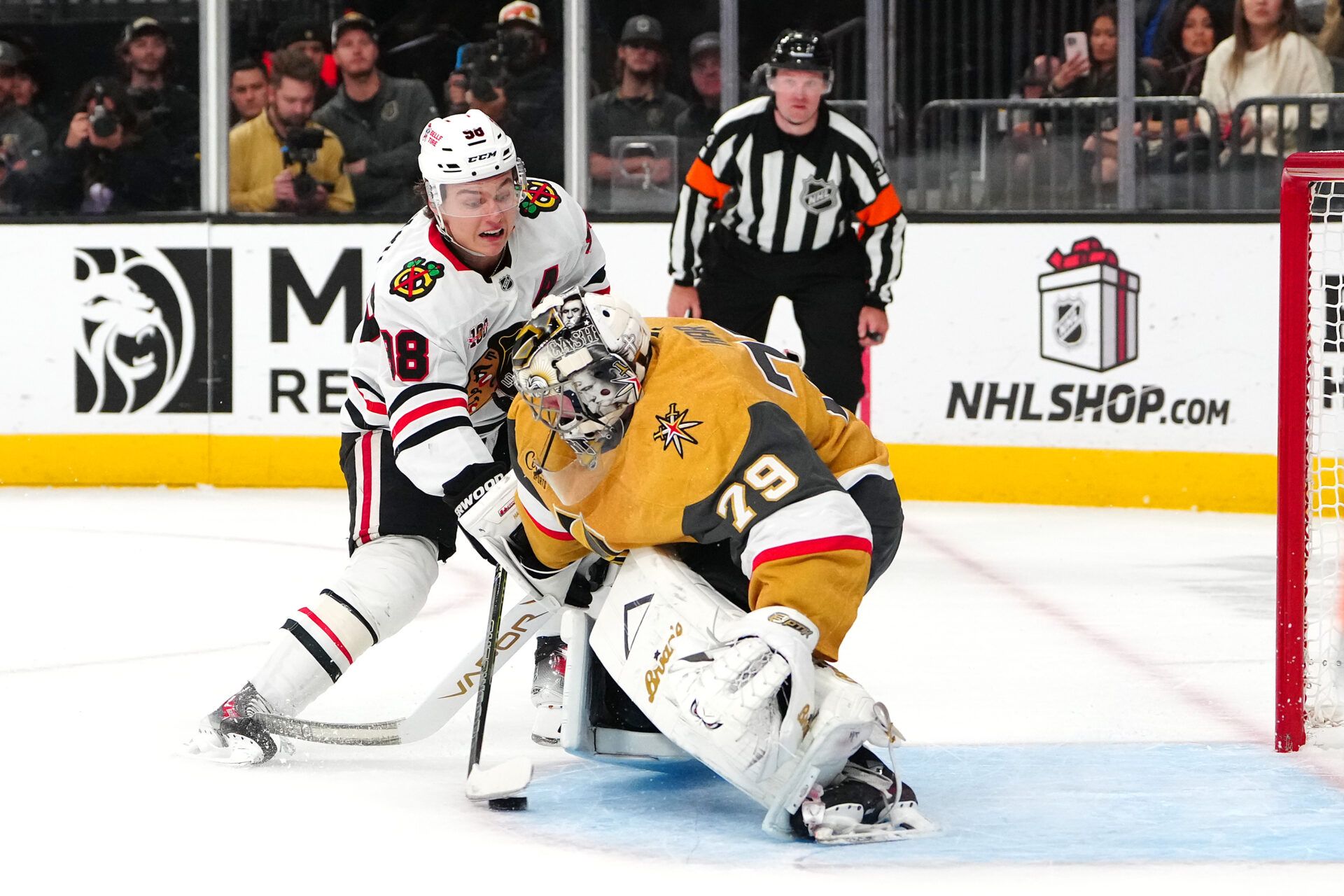 Chicago Blackhawks center Connor Bedard (98) scores a goal against Vegas Golden Knights goaltender Carter Hart (79) during a shoot out at T-Mobile Arena.