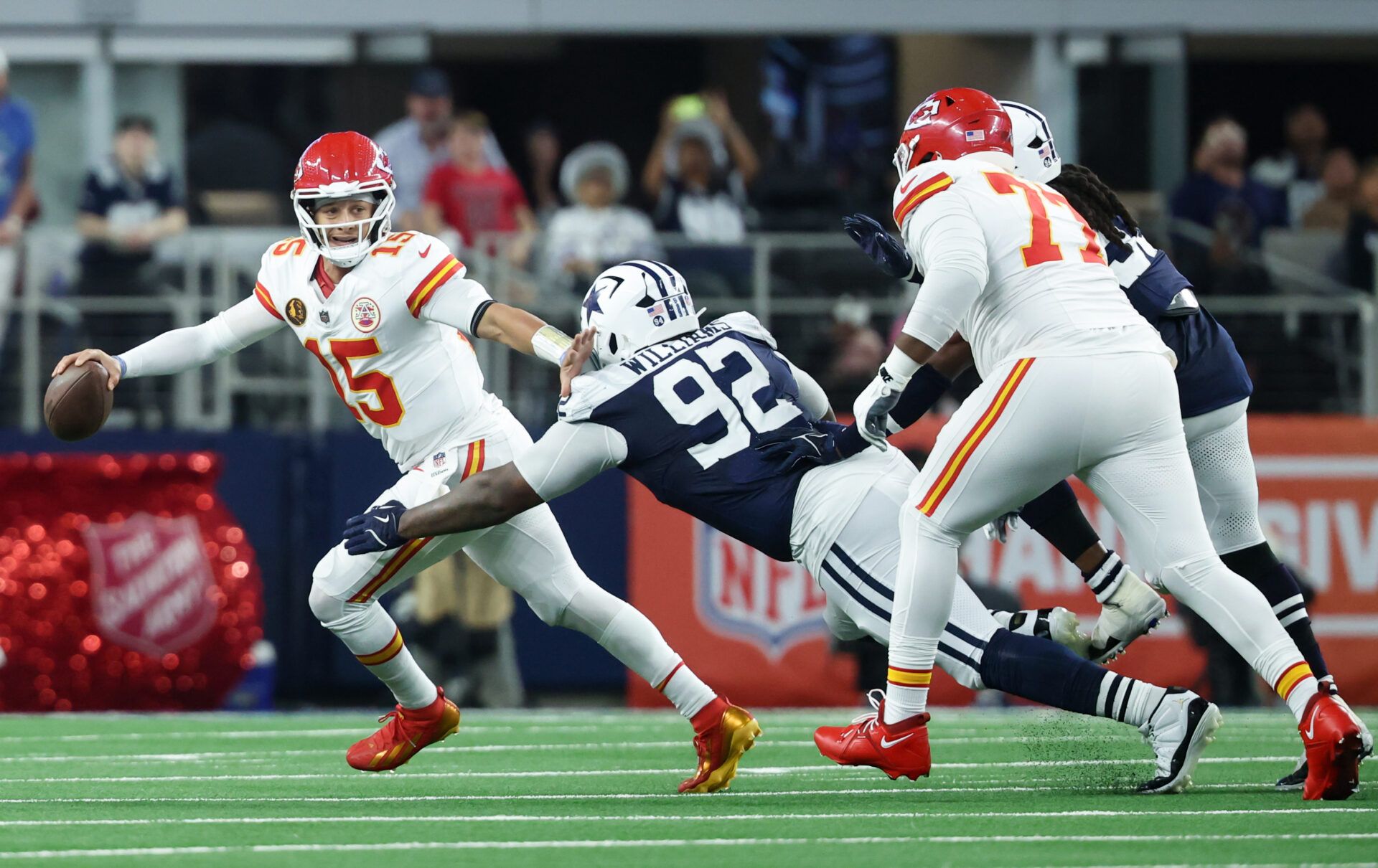 Kansas City Chiefs quarterback Patrick Mahomes (15) runs with the ball against Dallas Cowboys defensive tackle Quinnen Williams (92) during the second quarter at AT&T Stadium.