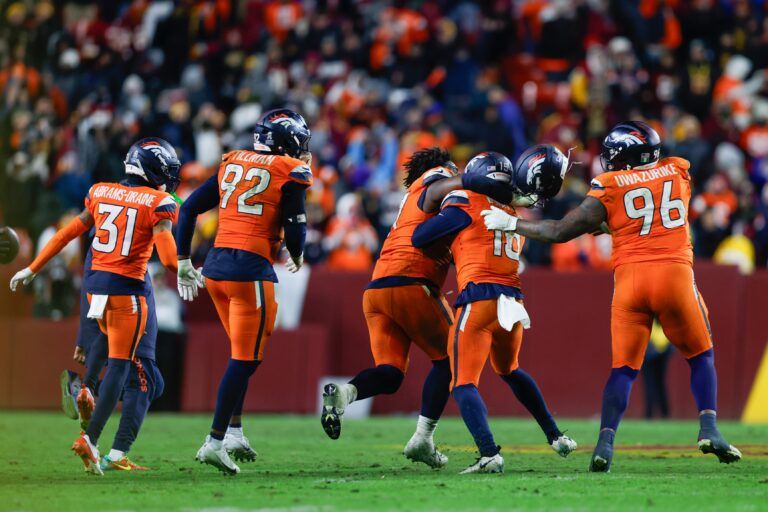 The Denver Broncos celebrate after the game against the Washington Commanders at Northwest Stadium.