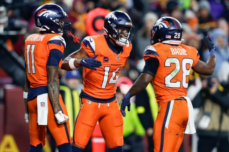 Denver Broncos wide receiver Courtland Sutton (14) celebrates after scoring a touchdown against the Washington Commanders with wide receiver Troy Franklin (11) and running back Tyler Badie (28) in the second quarter of the game at Northwest Stadium.