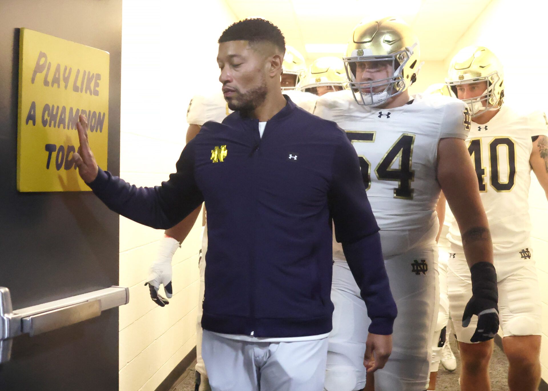 Notre Dame Fighting Irish head coach Marcus Freeman leads the team from the locker room to play the Pittsburgh Panthers at Acrisure Stadium.