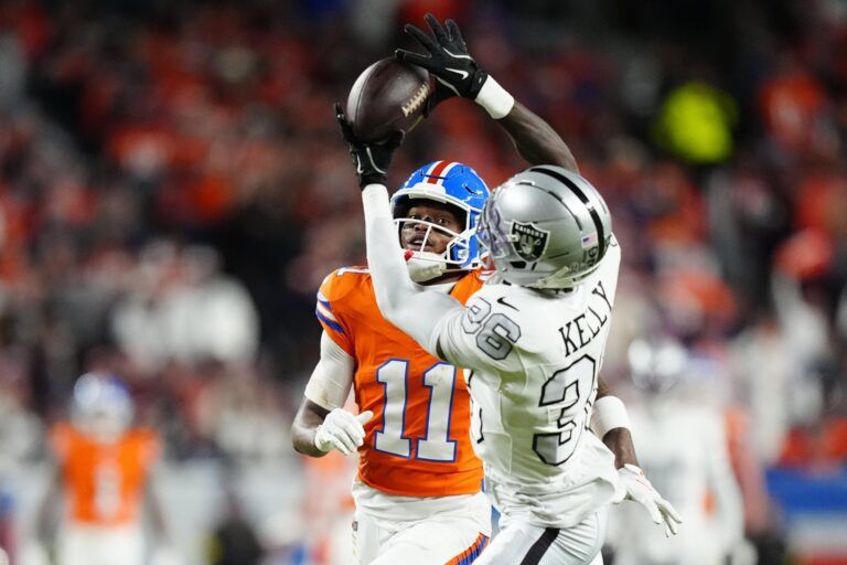 Las Vegas Raiders cornerback Kyu Blu Kelly (36) intercepts a pass for Denver Broncos wide receiver Troy Franklin (11) during the first half at Empower Field at Mile High.