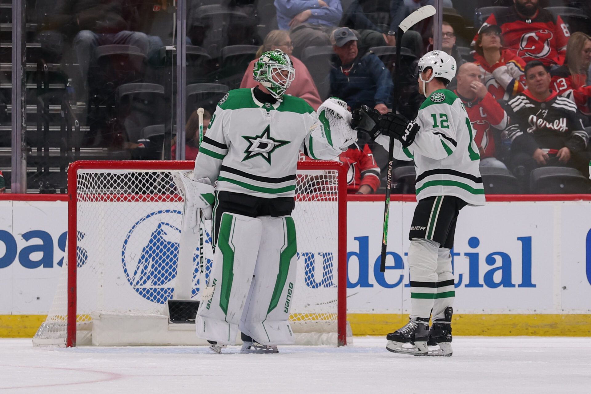 Dallas Stars goaltender Jake Oettinger (29) and center Radek Faksa (12) celebrate their win over the New Jersey Devils  at Prudential Center.
